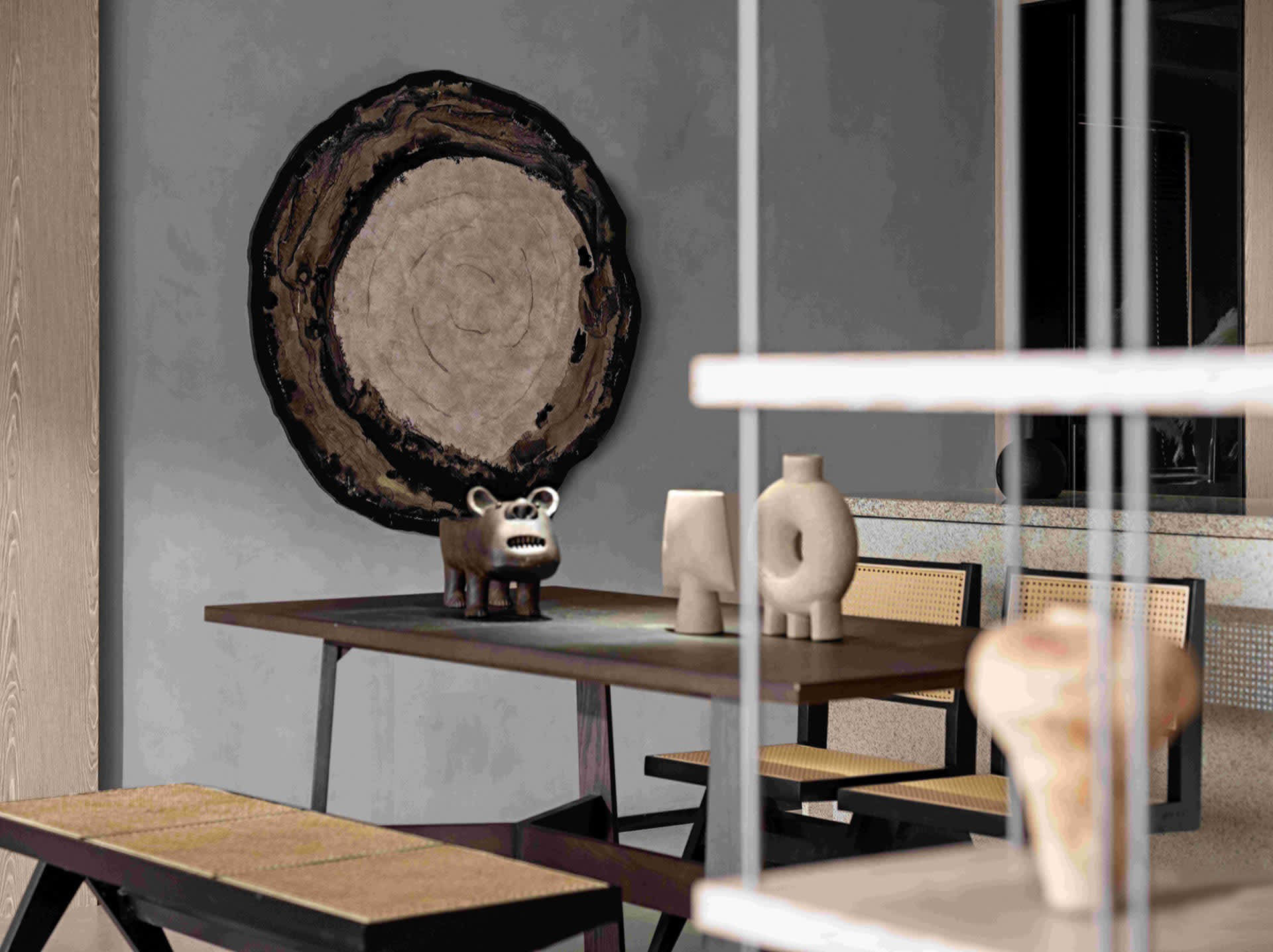 Modern dining room featuring a wooden table and chairs, with decorative items on the table and a large, circular wood slice w
