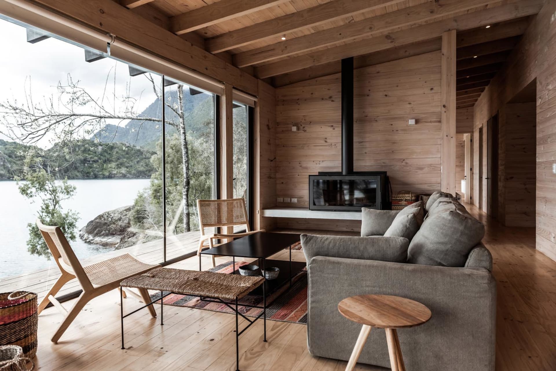 Modern living room with wooden furniture and a view of the natural surroundings.