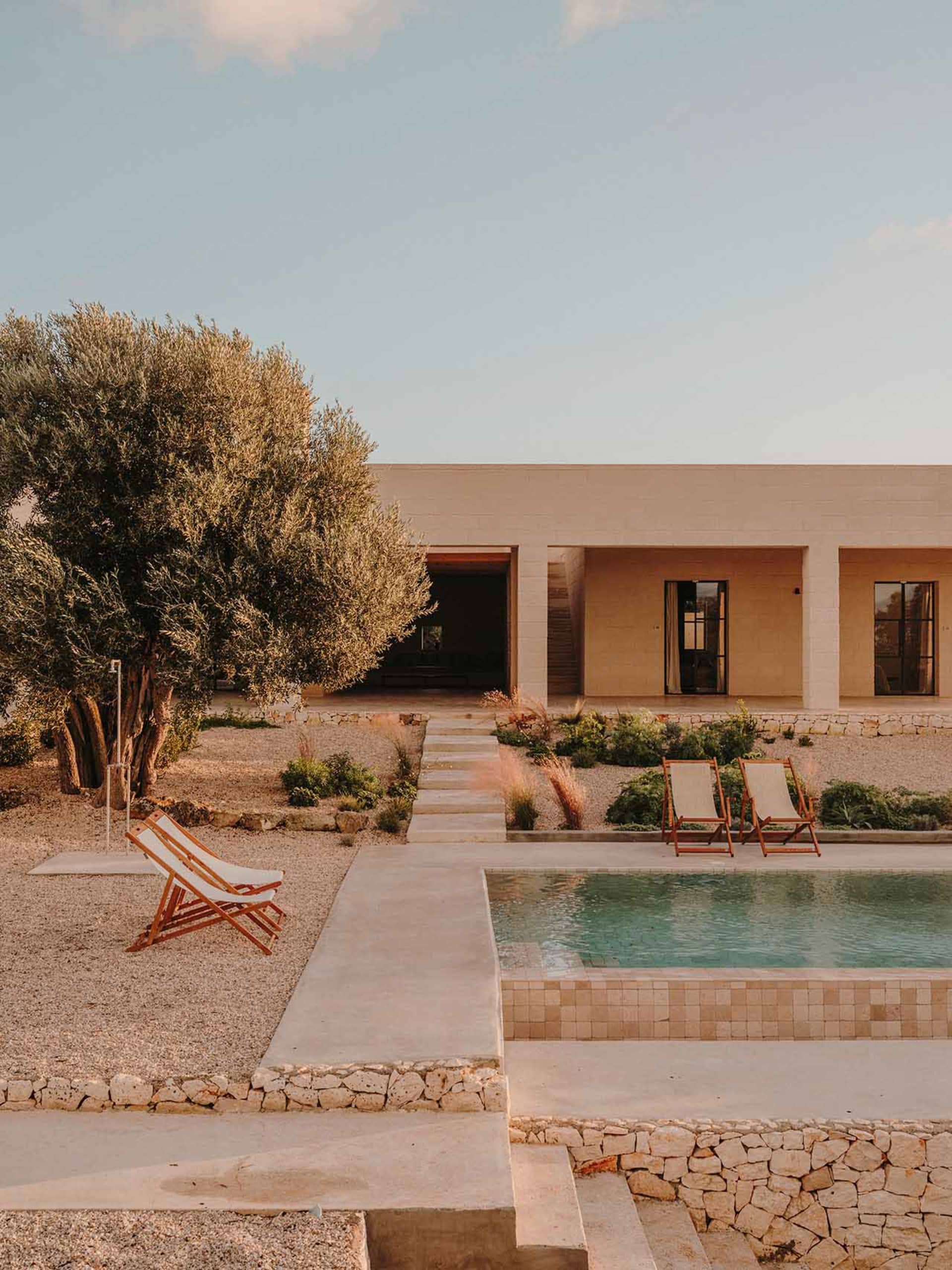 A modern residential exterior with concrete and stone materials.