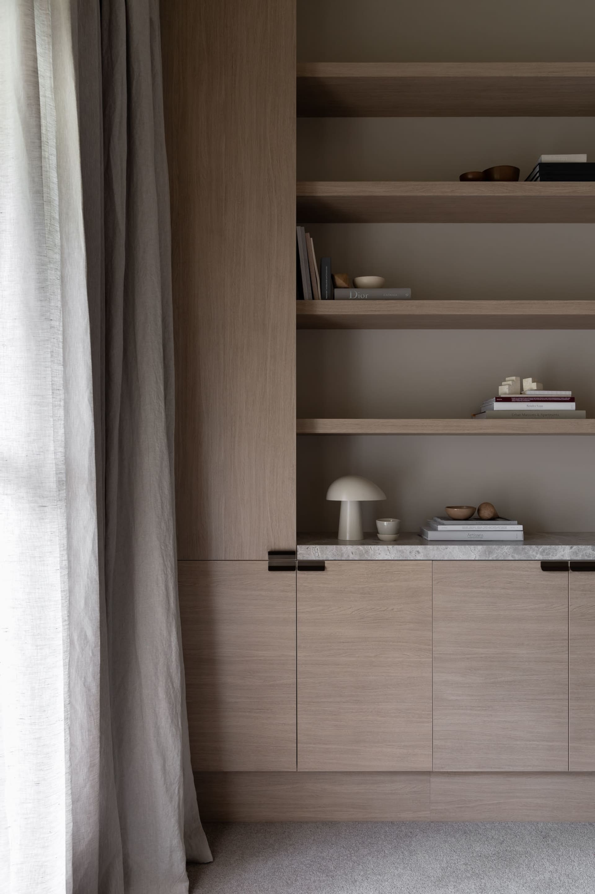 A modern bookshelf with wooden cabinets and wooden shelves.