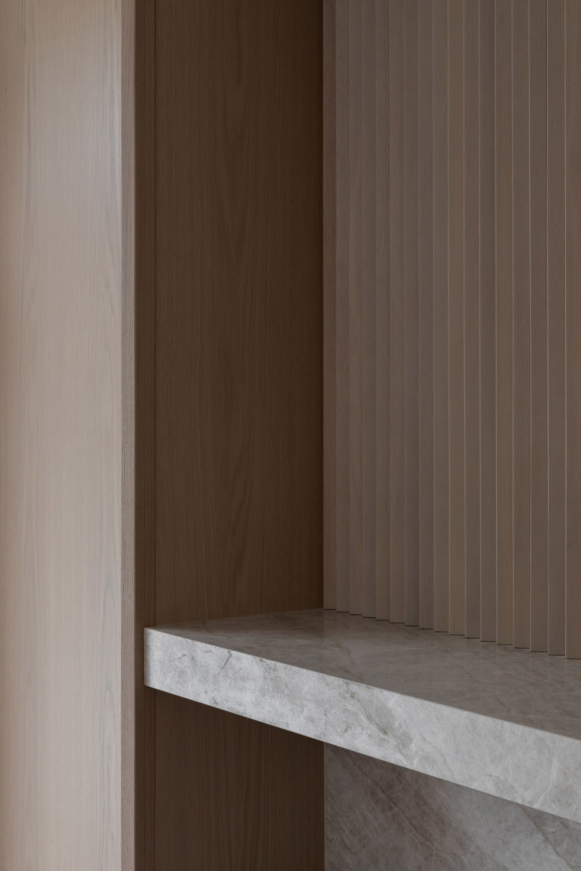 A minimalist interior design featuring marble and concrete materials.