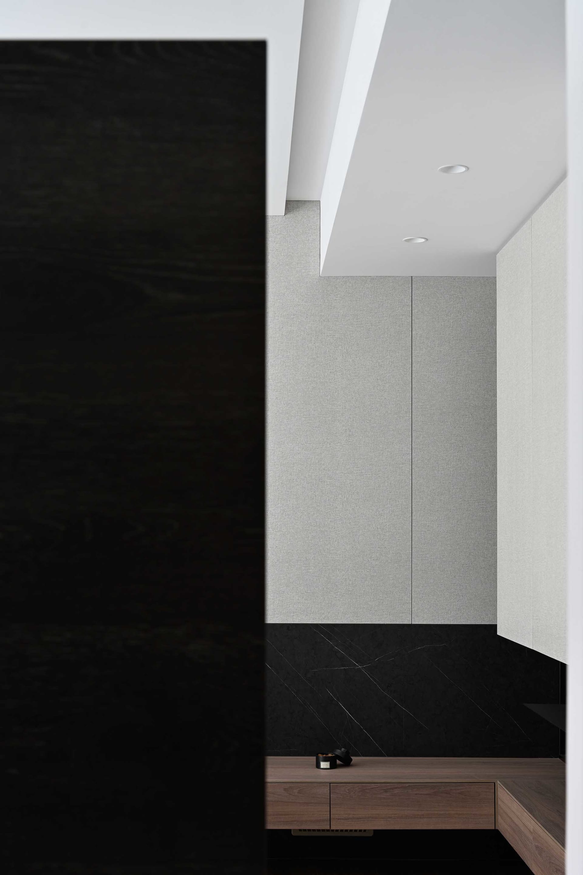 Modern closet interior featuring gray tiles and black ground.