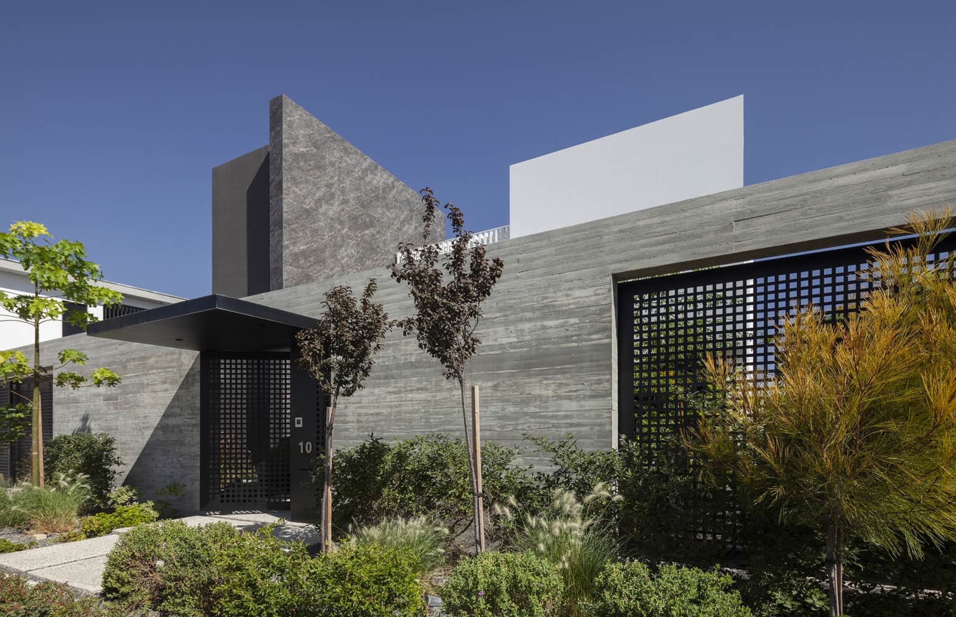 Modern building with concrete facade and plants