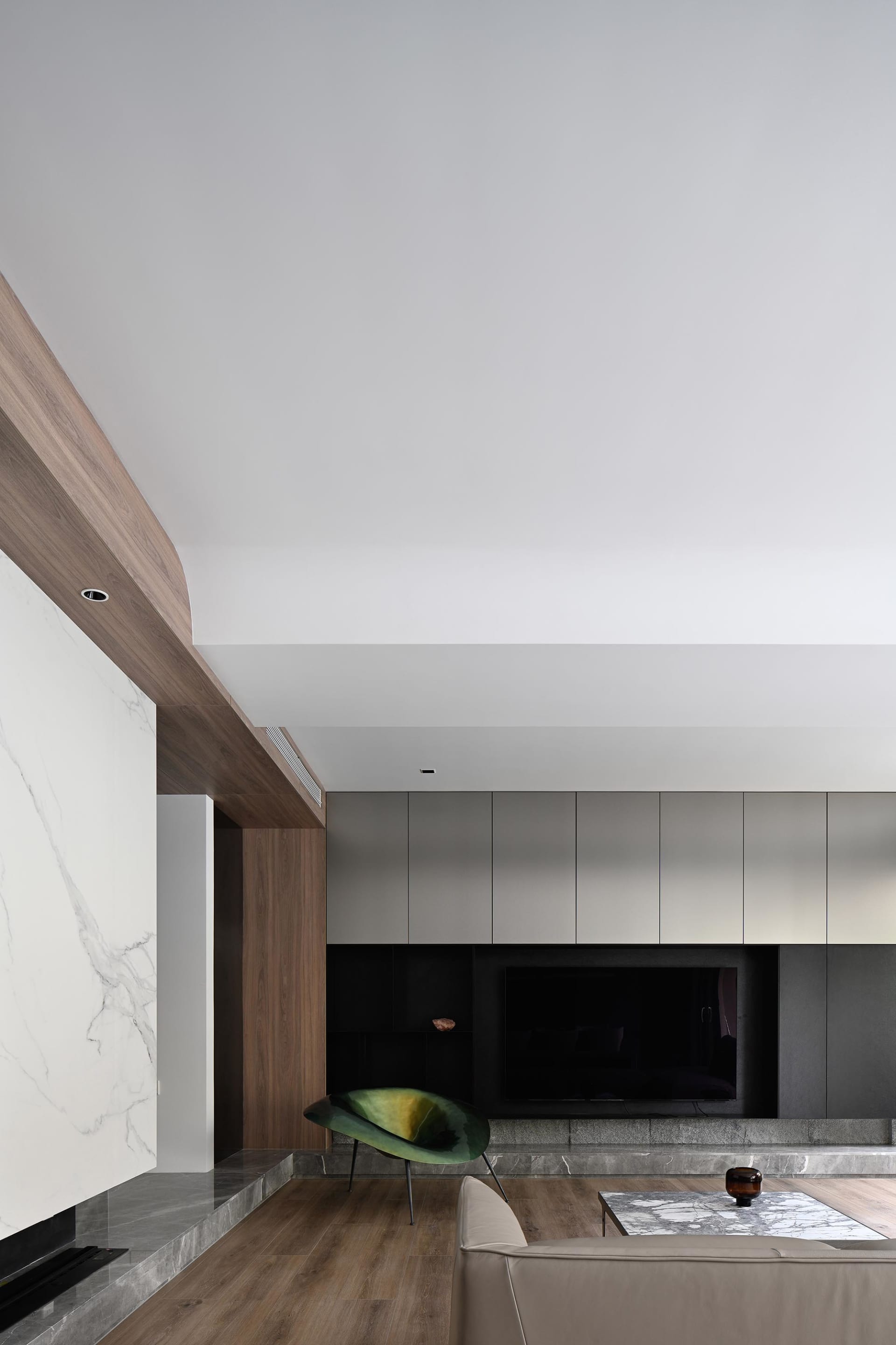 A modern living room featuring marble and wooden elements.