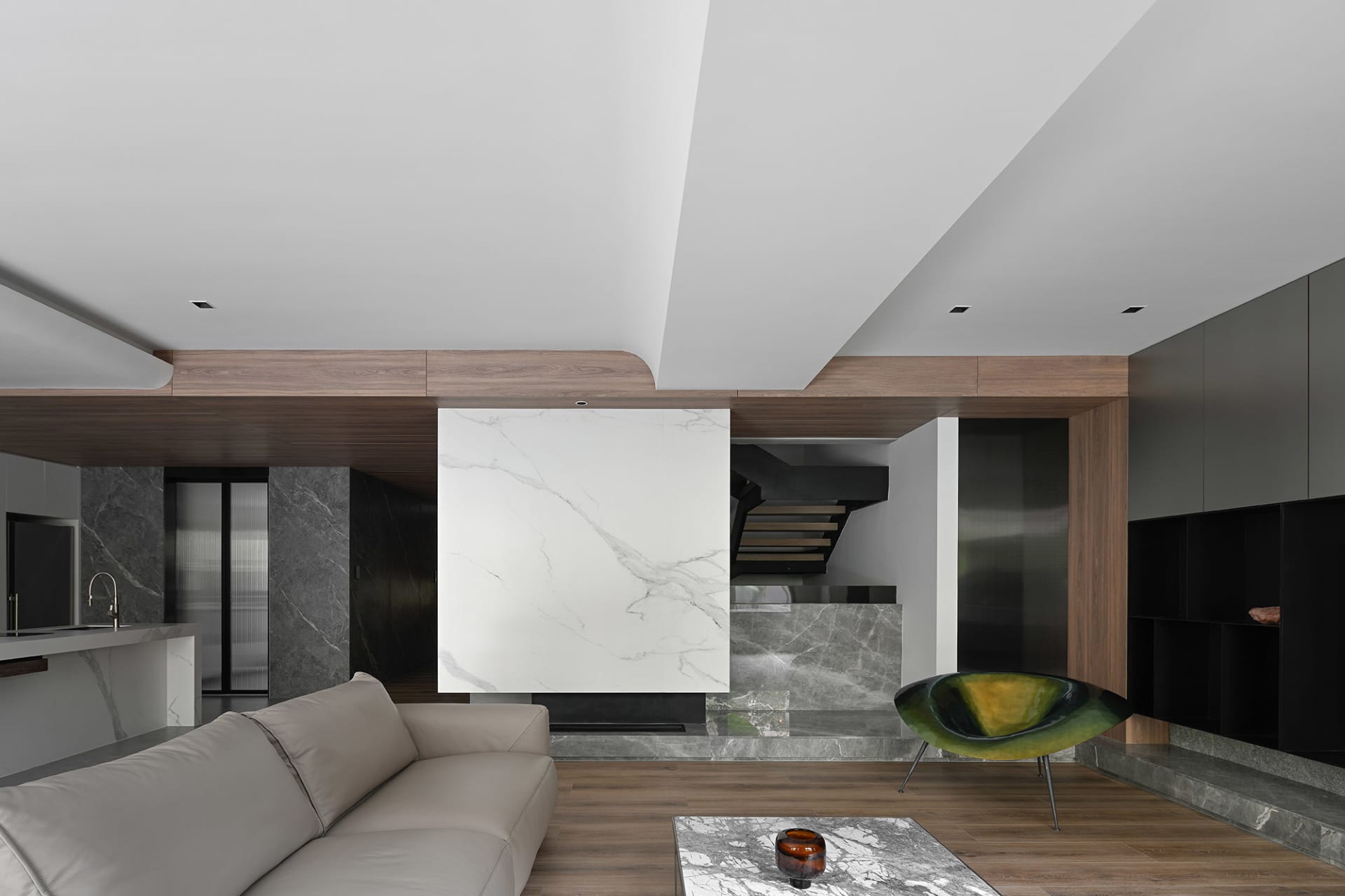 A modern living room featuring marble accents and wooden elements.