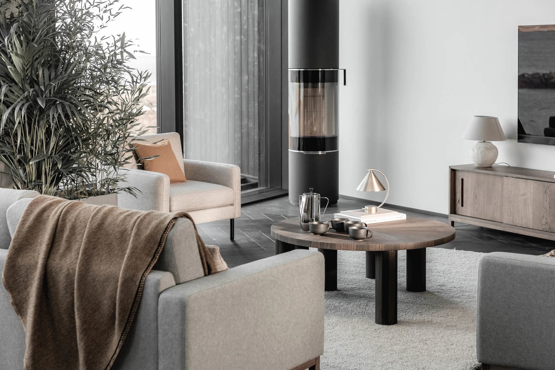 Modern living room featuring wood and metal furniture and decor elements.