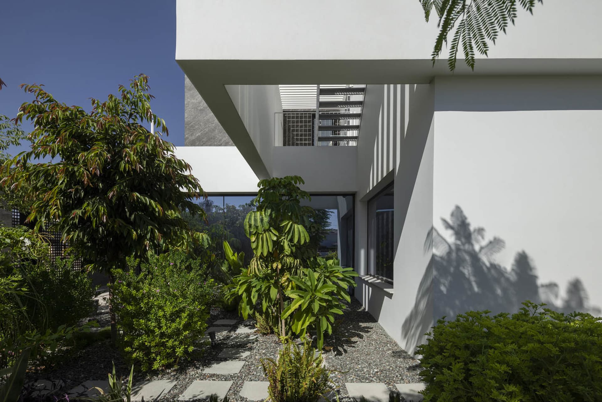 Modern residential building with concrete walls and glass windows.