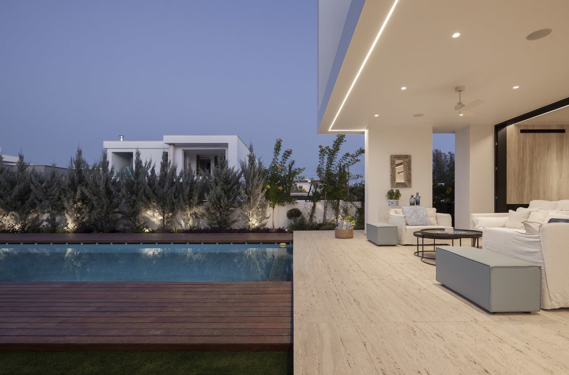 Modern residential house with swimming pool and veranda, featuring marble floor and glass walls.