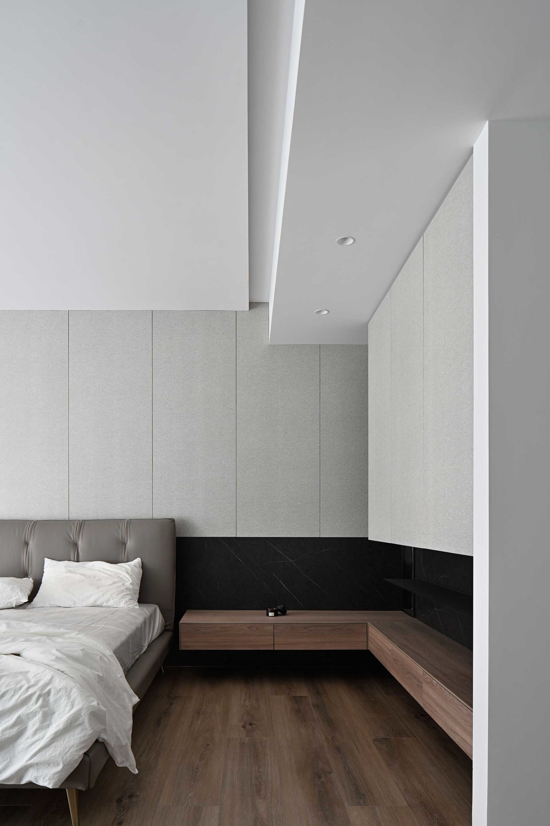 Modern bedroom featuring stylish wooden furniture and contemporary design elements.