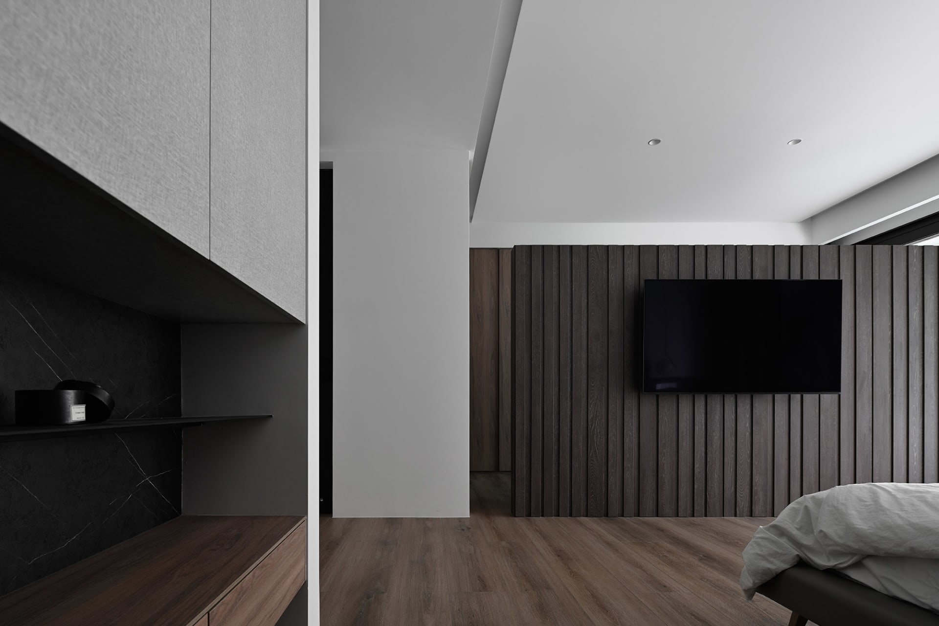 A modern bedroom featuring dark wood paneling
