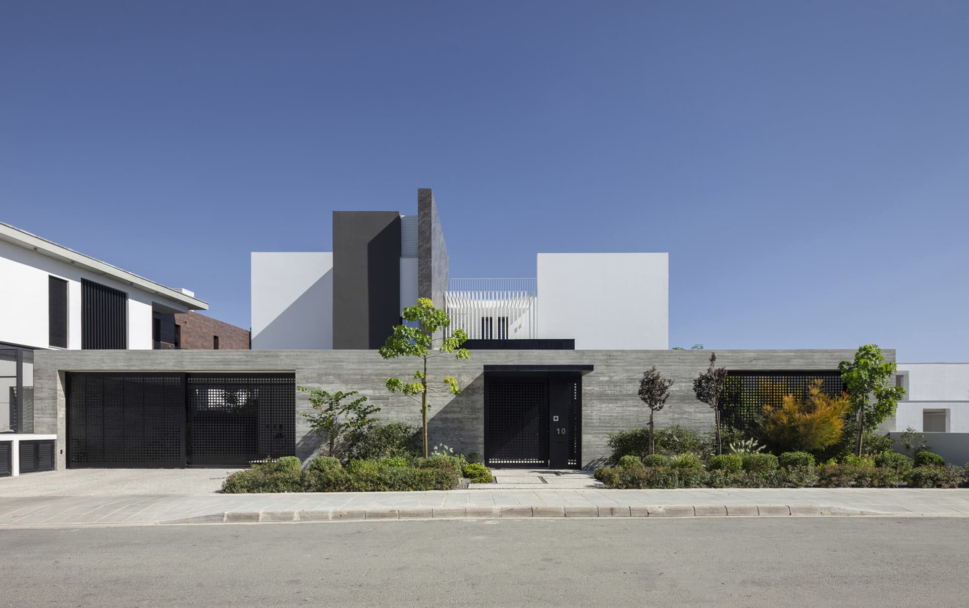 A modern house featuring a contemporary design with concrete as the primary material.