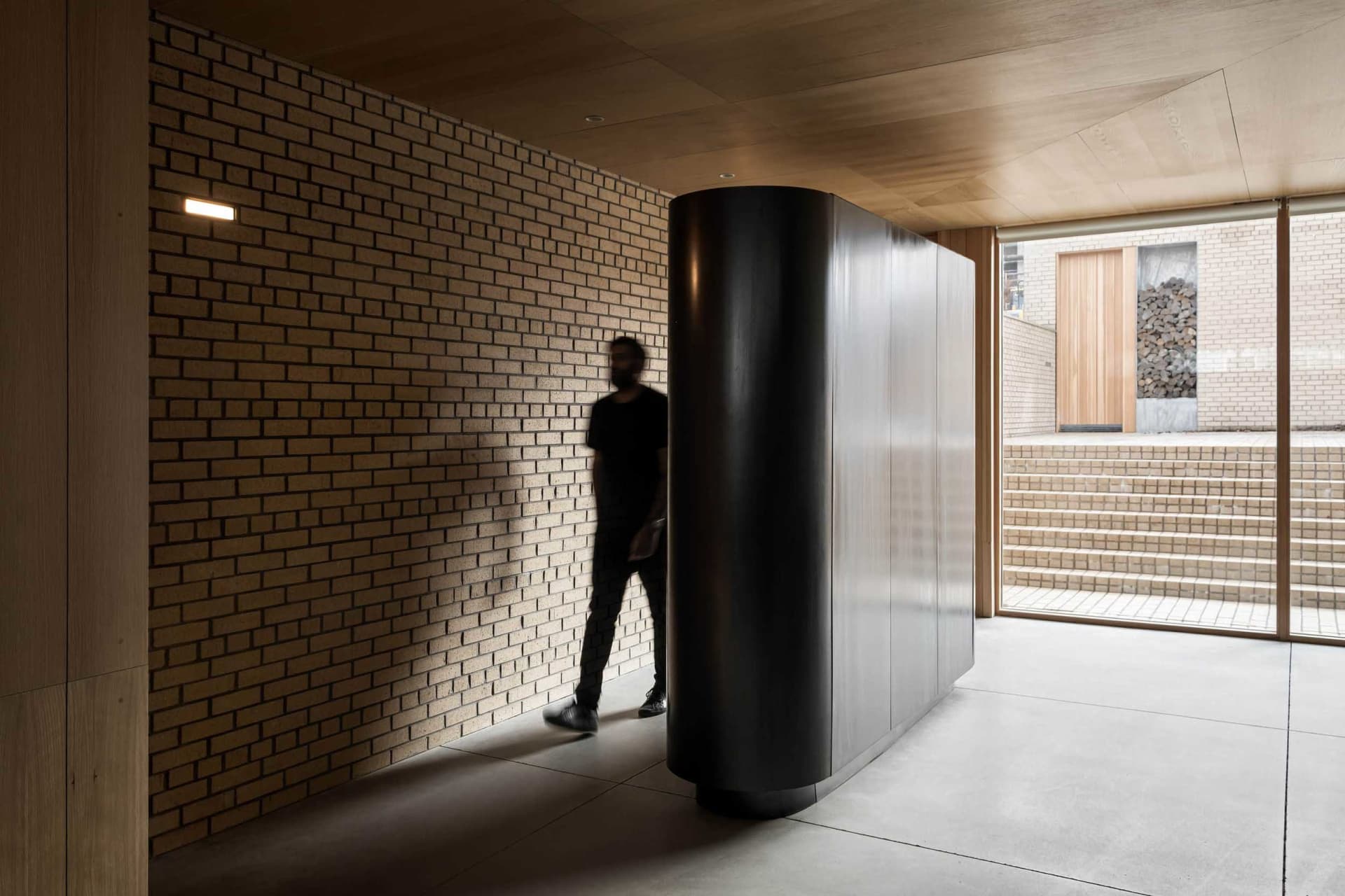 A modern hallway featuring brick and concrete materials.