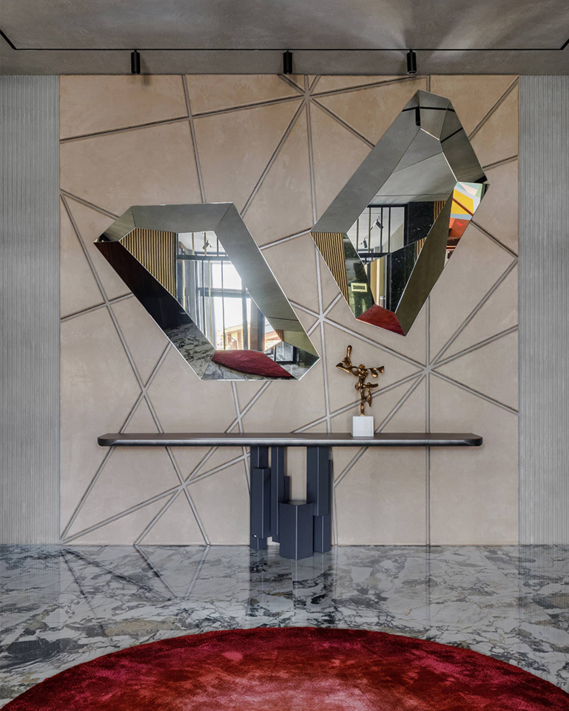 Modern interior with a metal mirror, marble console table, and carpet