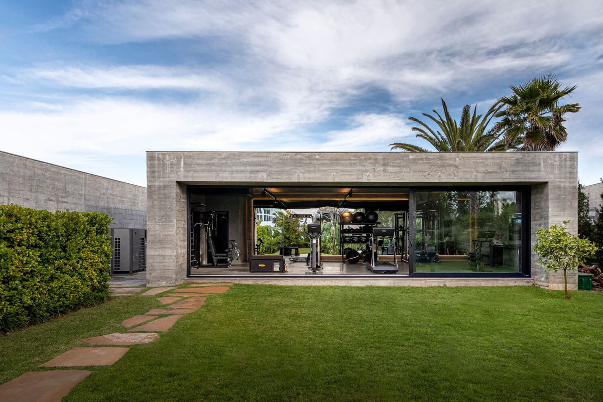 Modern outdoor gym with concrete structure and lawn