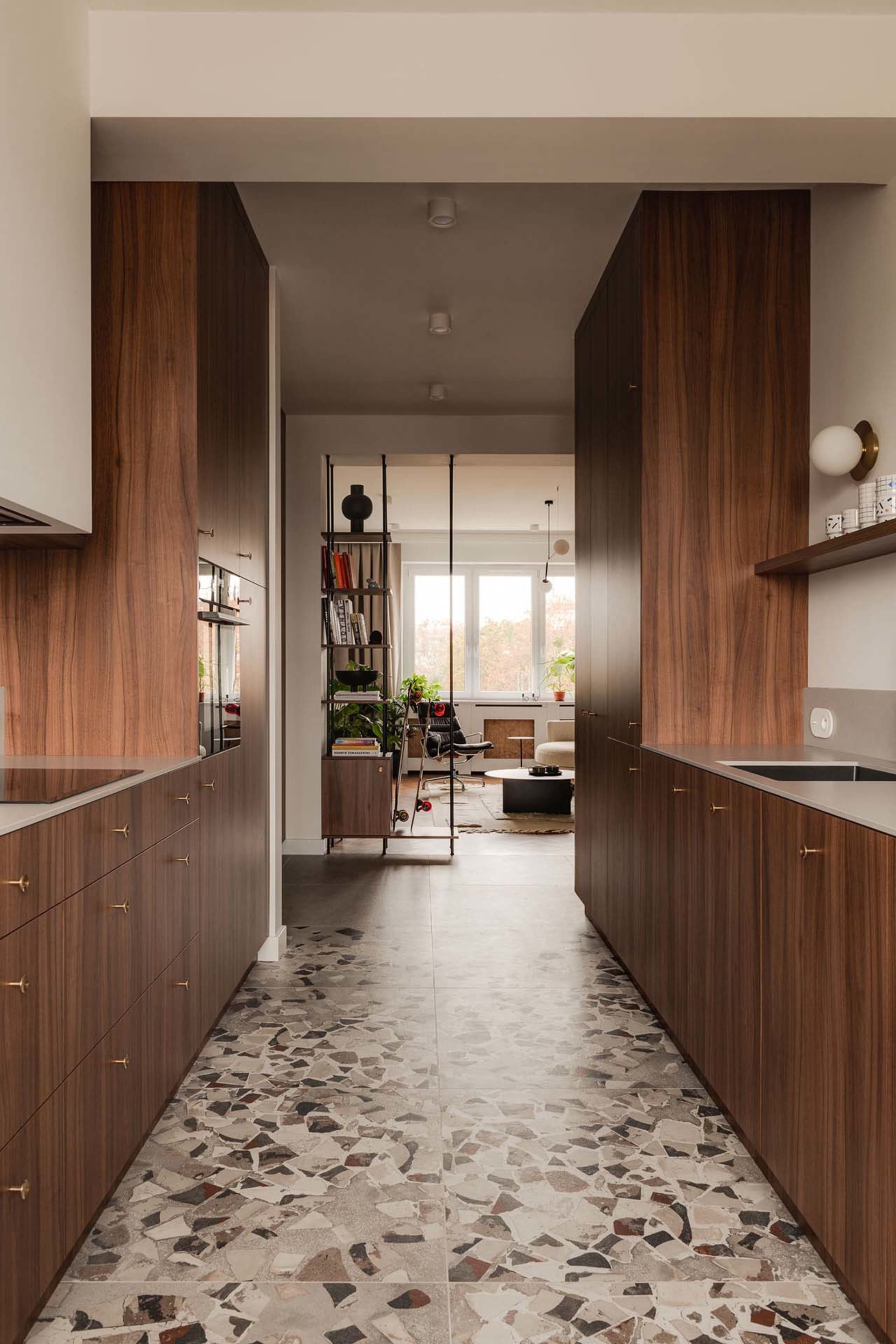 Modern kitchen featuring terrazzo flooring and wooden cabinetry.
