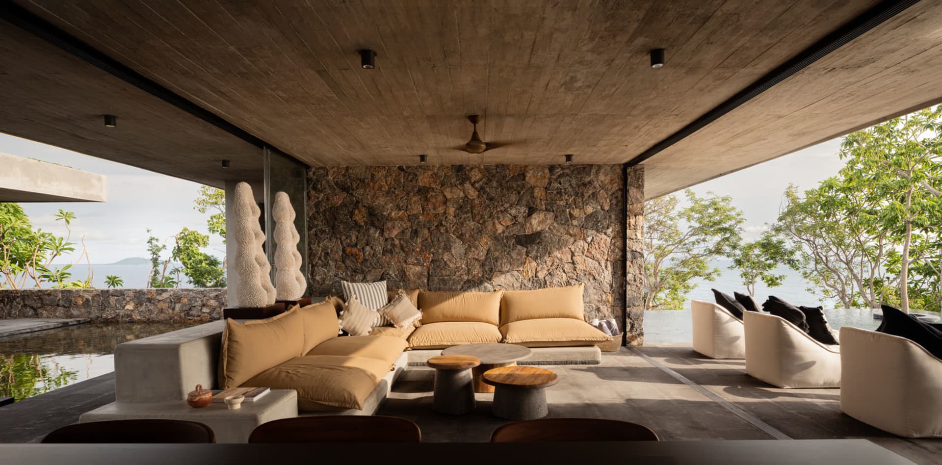Modern minimalist living room with concrete and stone accents.