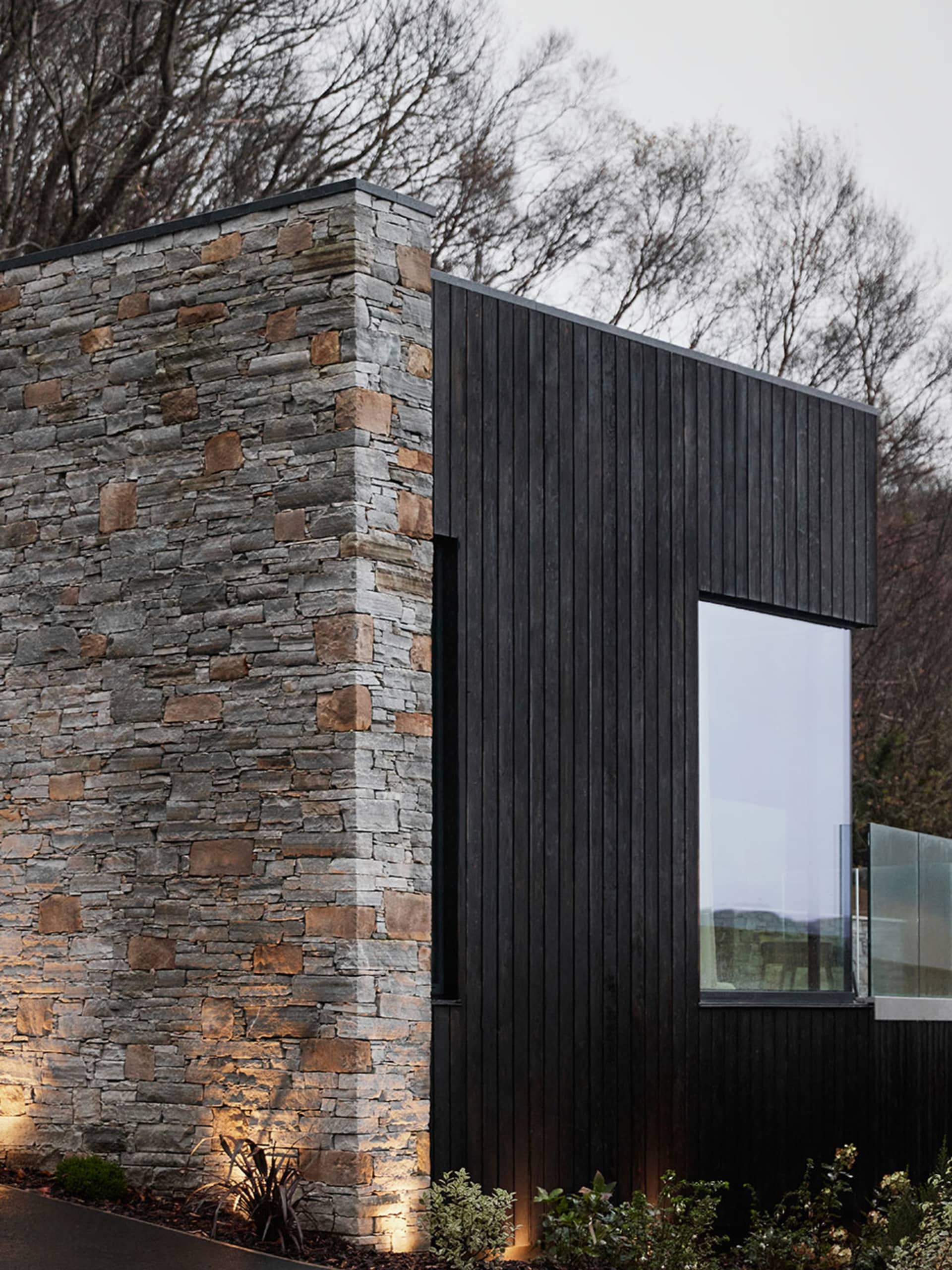 Modern building exterior featuring stone and wooden accents