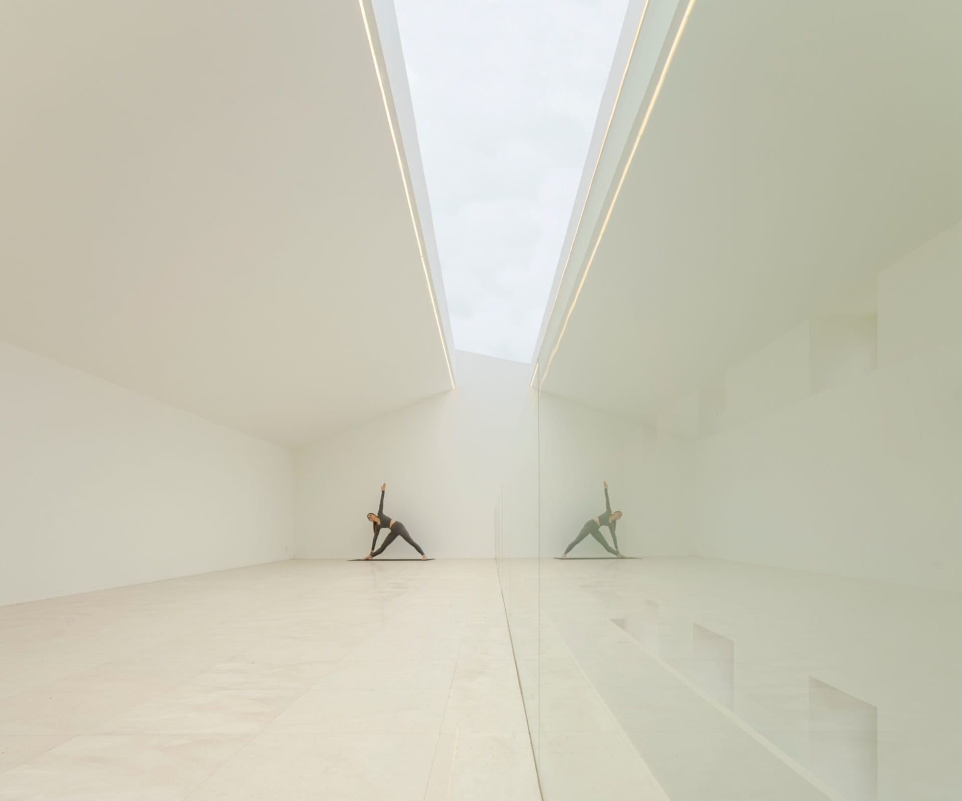 A modern interior space with a white glass ceiling and minimalist design.