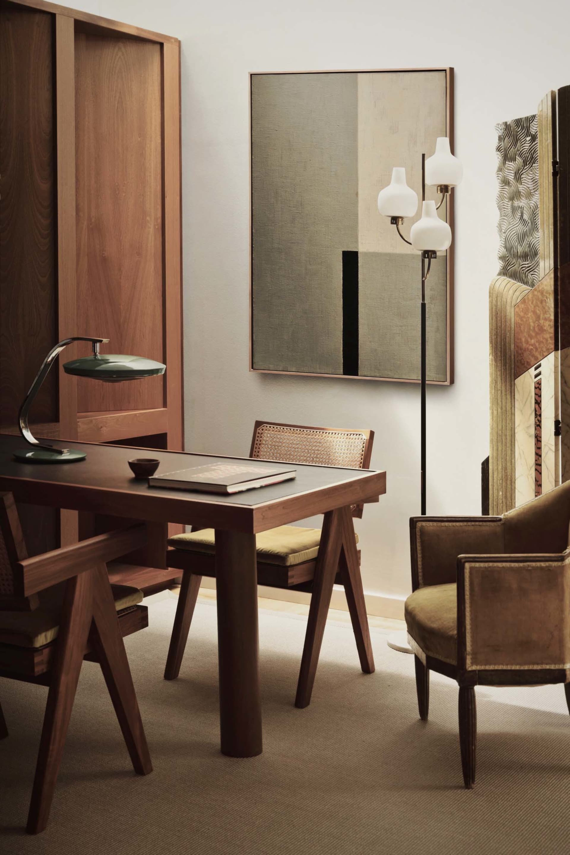 Modern interior design featuring wooden furniture and leather accents in a home office setting.
