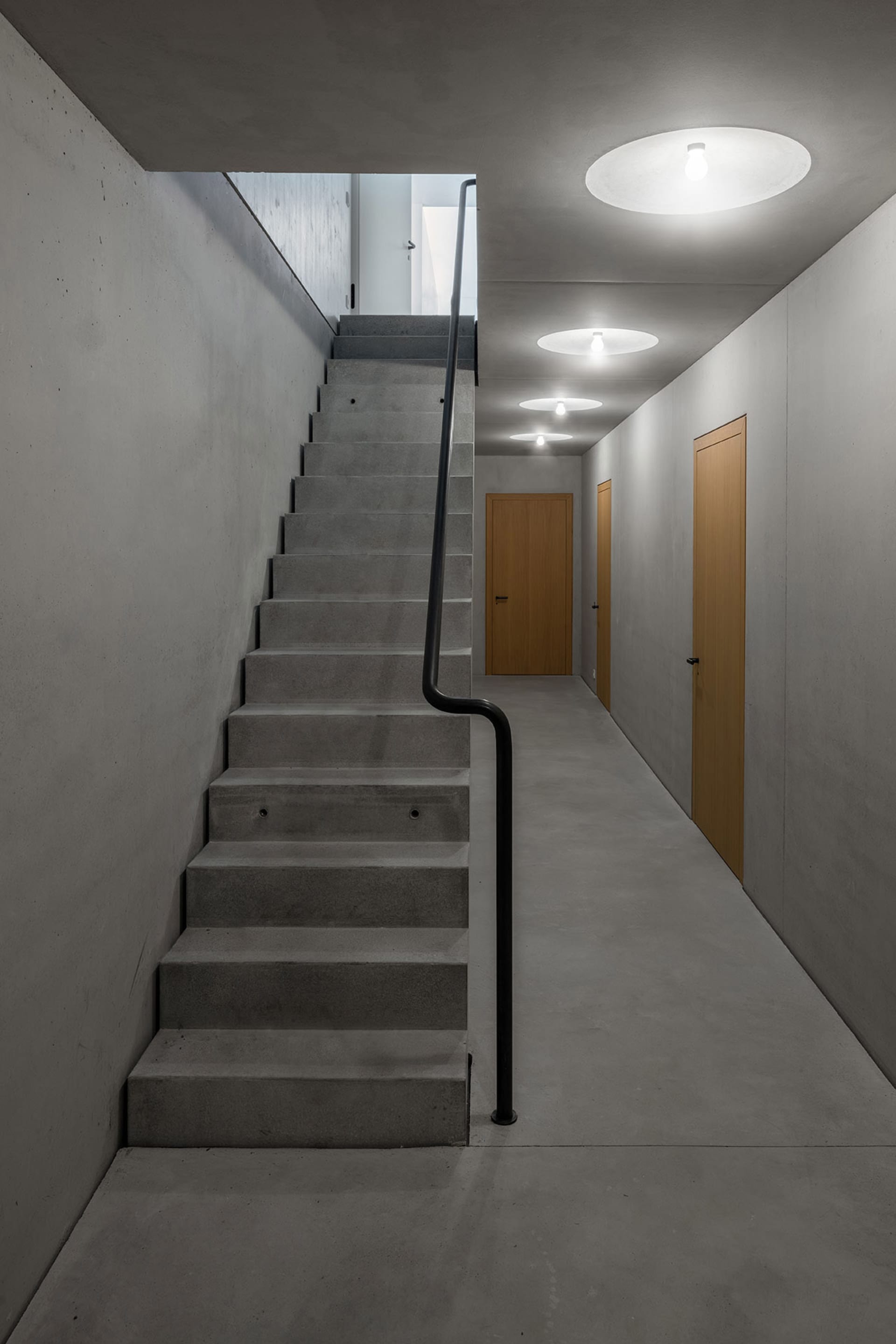 Concrete stairwell with minimalist design and dark color.
