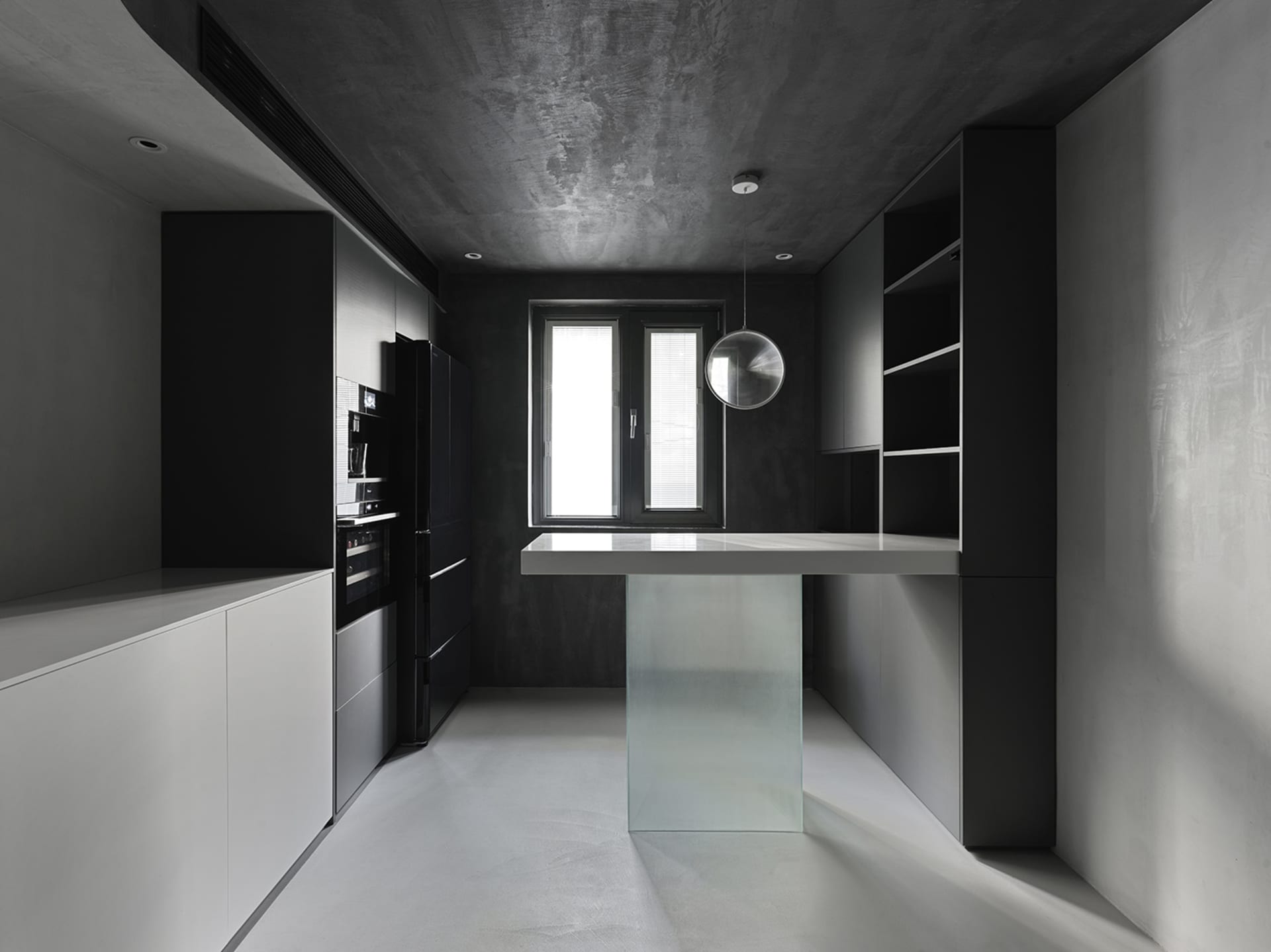 Modern kitchen featuring black and white design with concrete elements