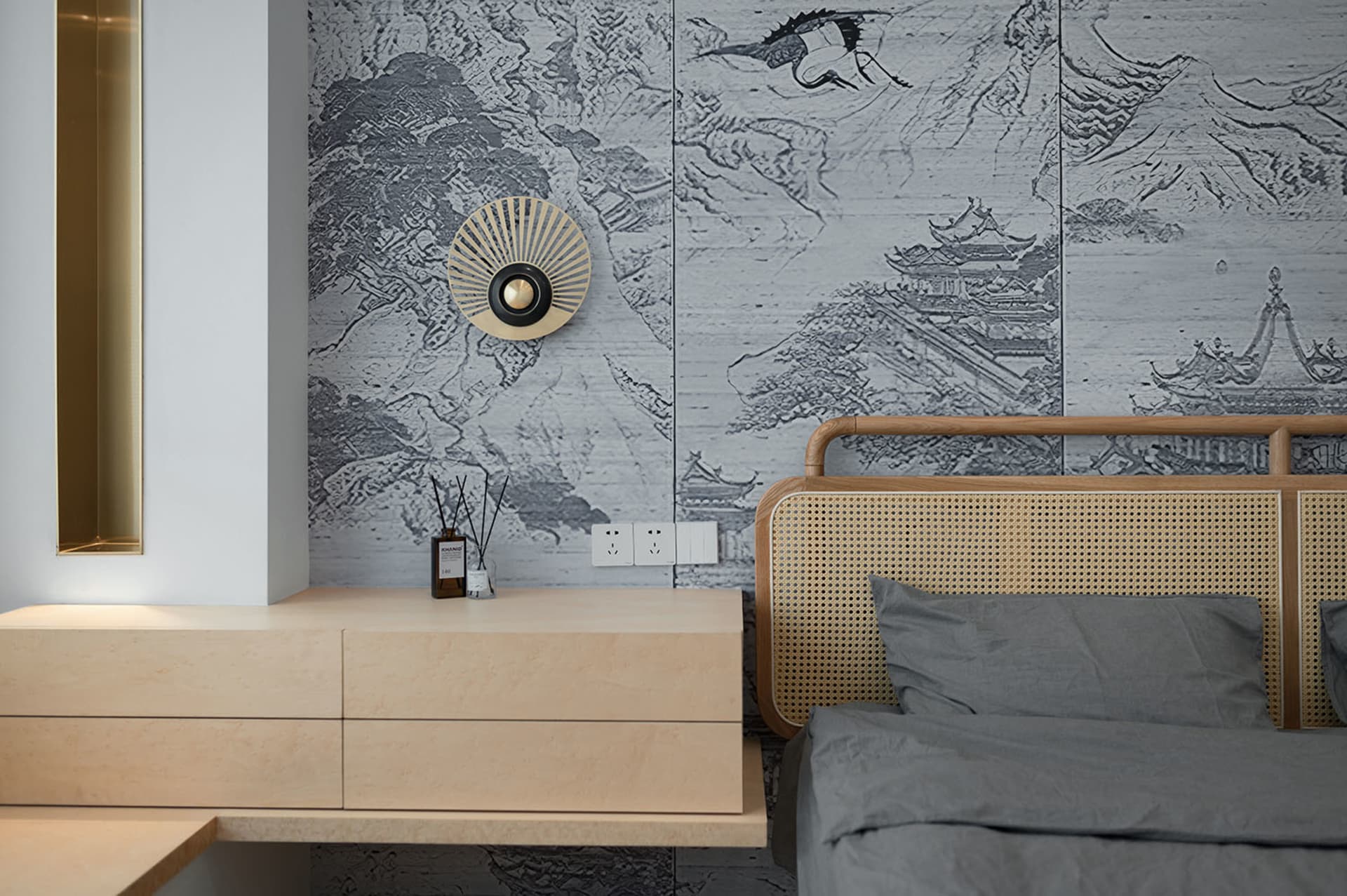 A modern minimalist bedroom with a wooden bed and a textured wall pattern featuring mountainous and architectural elements.
