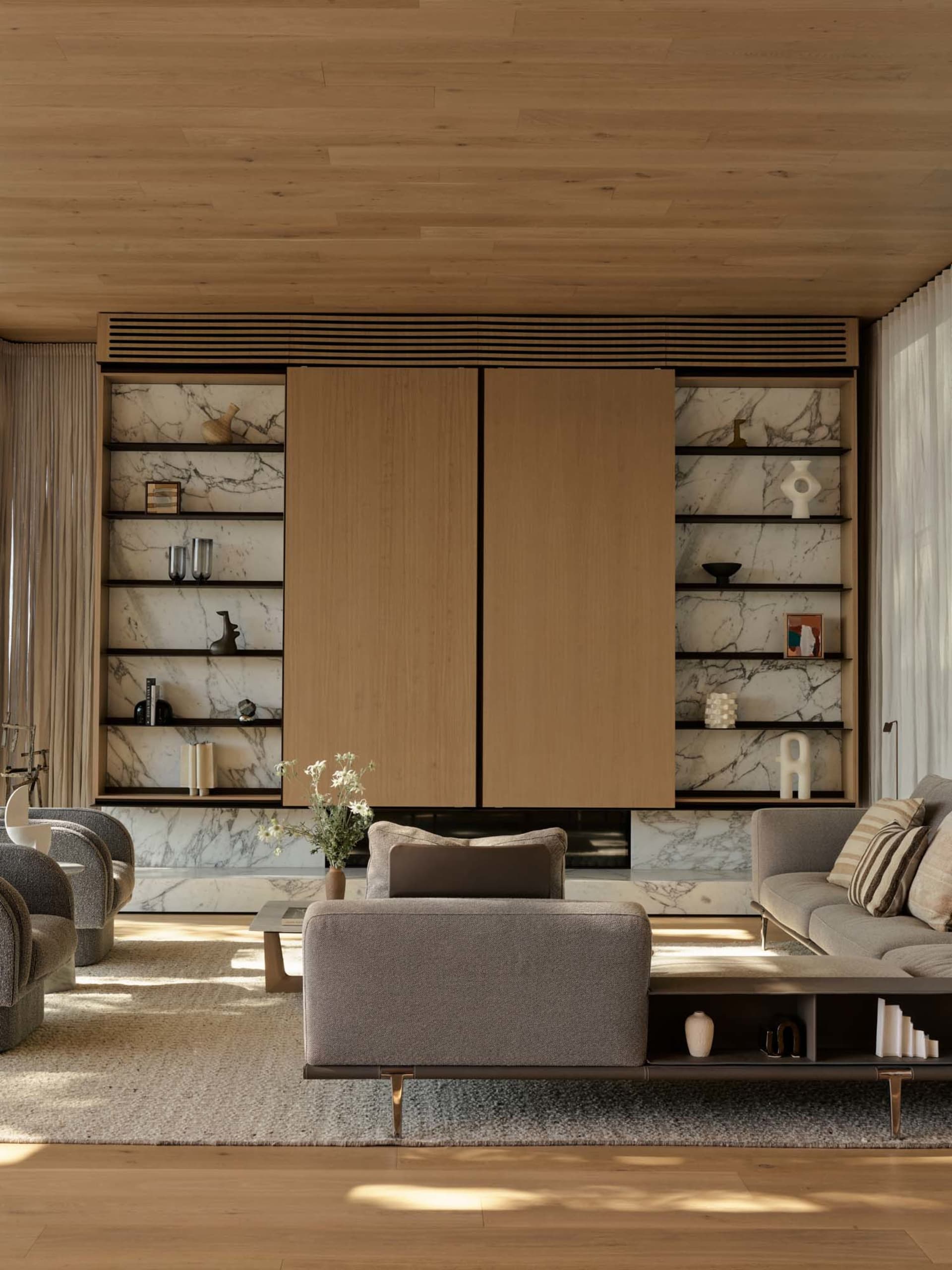 Contemporary living room featuring marble accents and wooden furnishings.