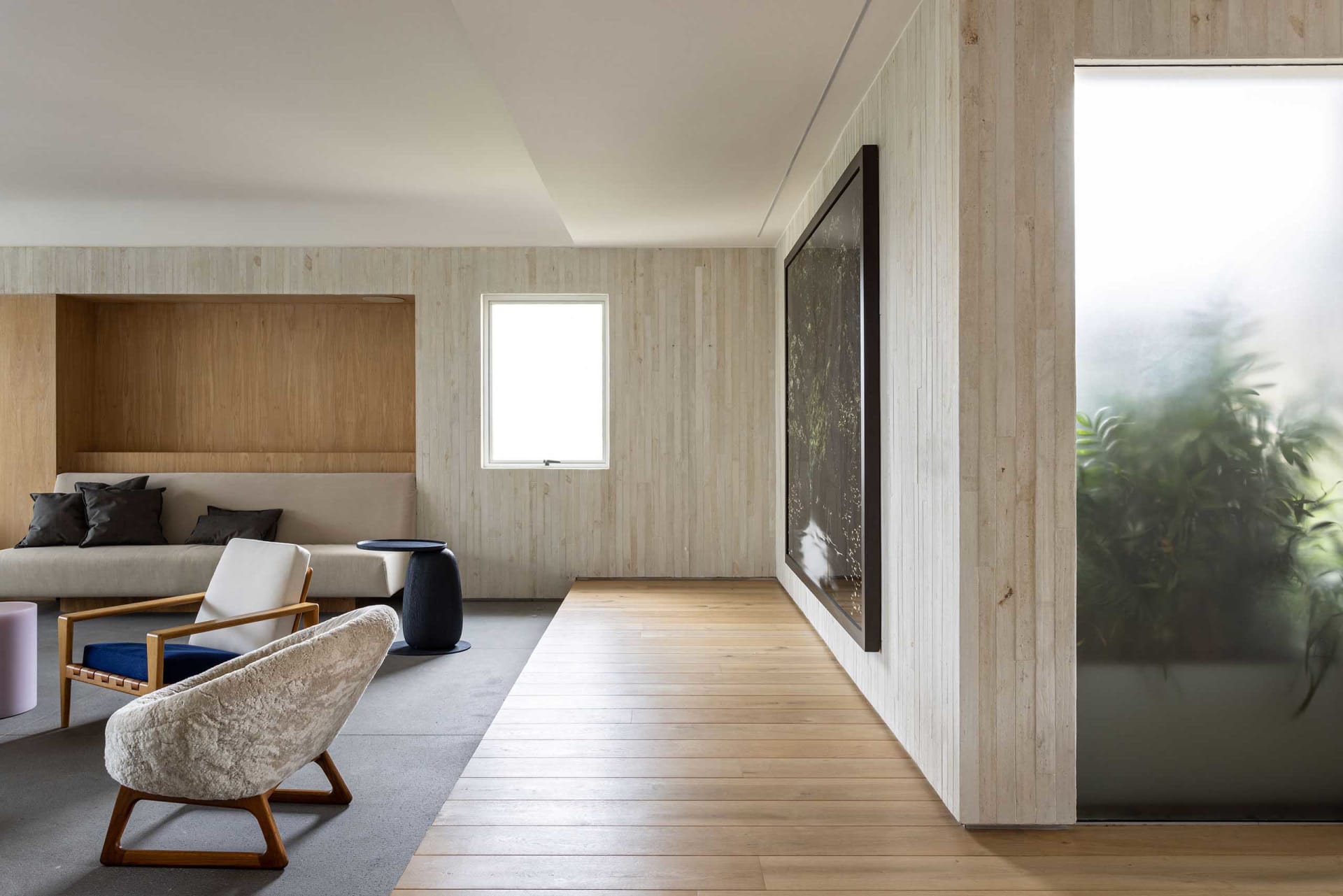 A modern living room featuring wood and concrete materials.