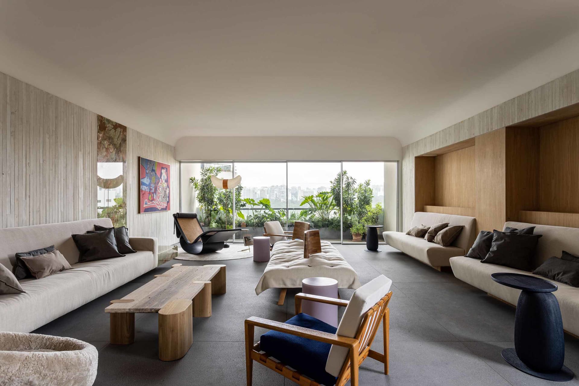 A modern living room featuring white sofas, wooden furniture, and a mix of materials.