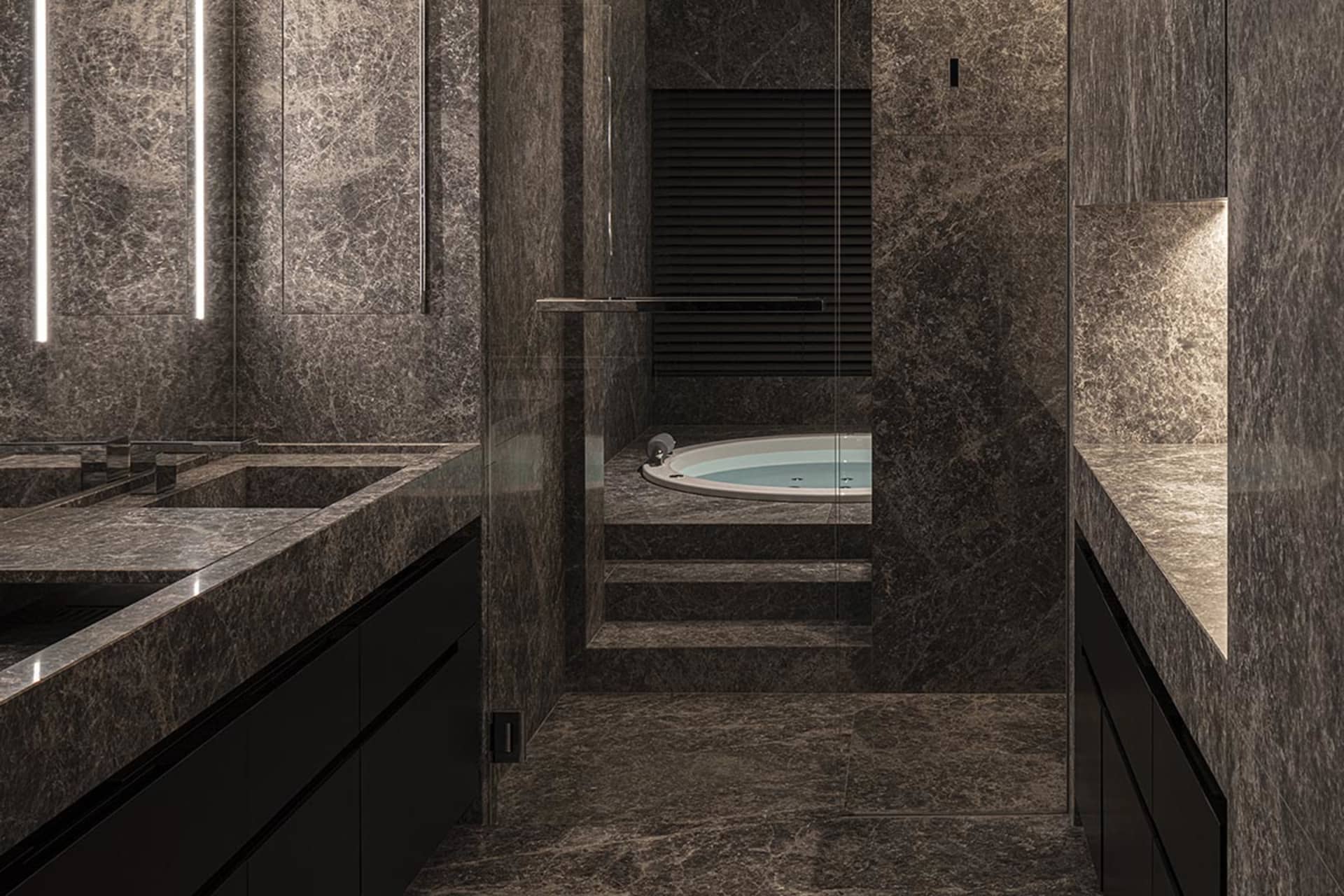 A modern, industrial-style bathroom with dark marble walls and a built-in bathtub.