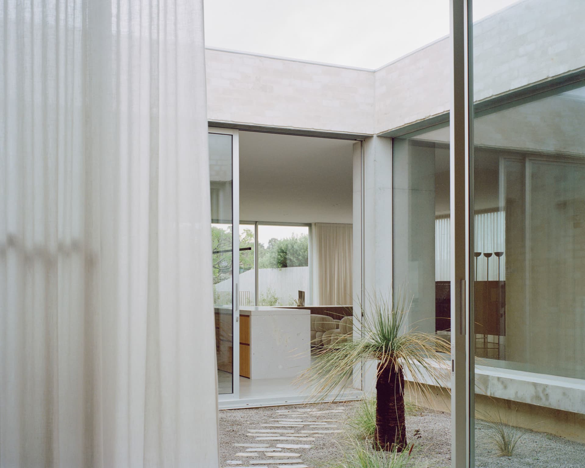 Modern interior design featuring glass and concrete materials.