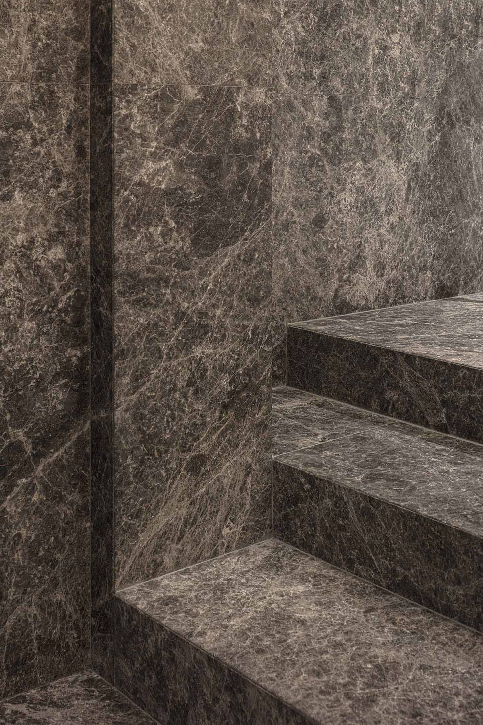 Minimalist staircase made of polished marble, showcasing contemporary design principles with an accent on natural materials.