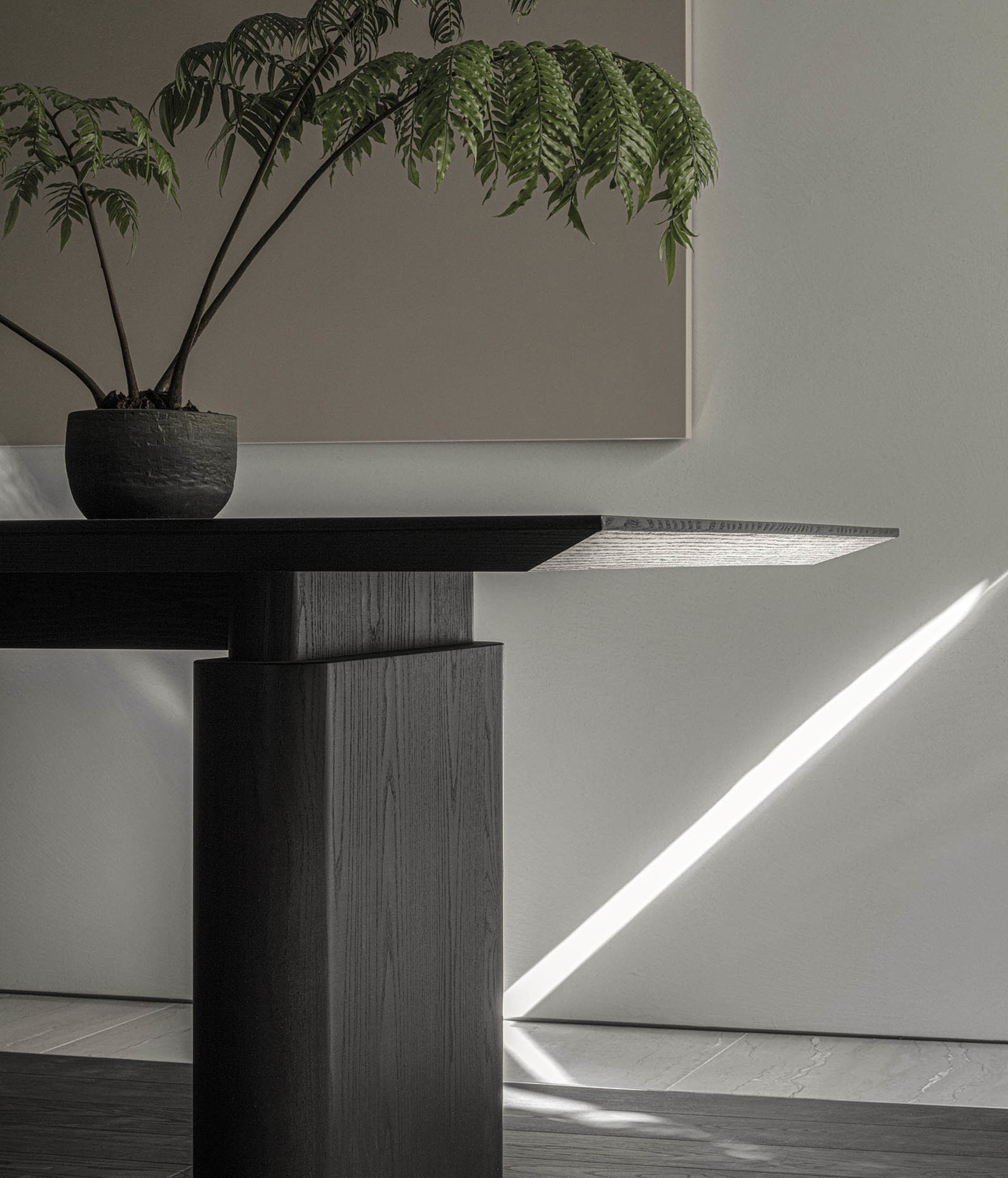 Modern interior design featuring a wooden console table with built-in lighting and a potted plant.