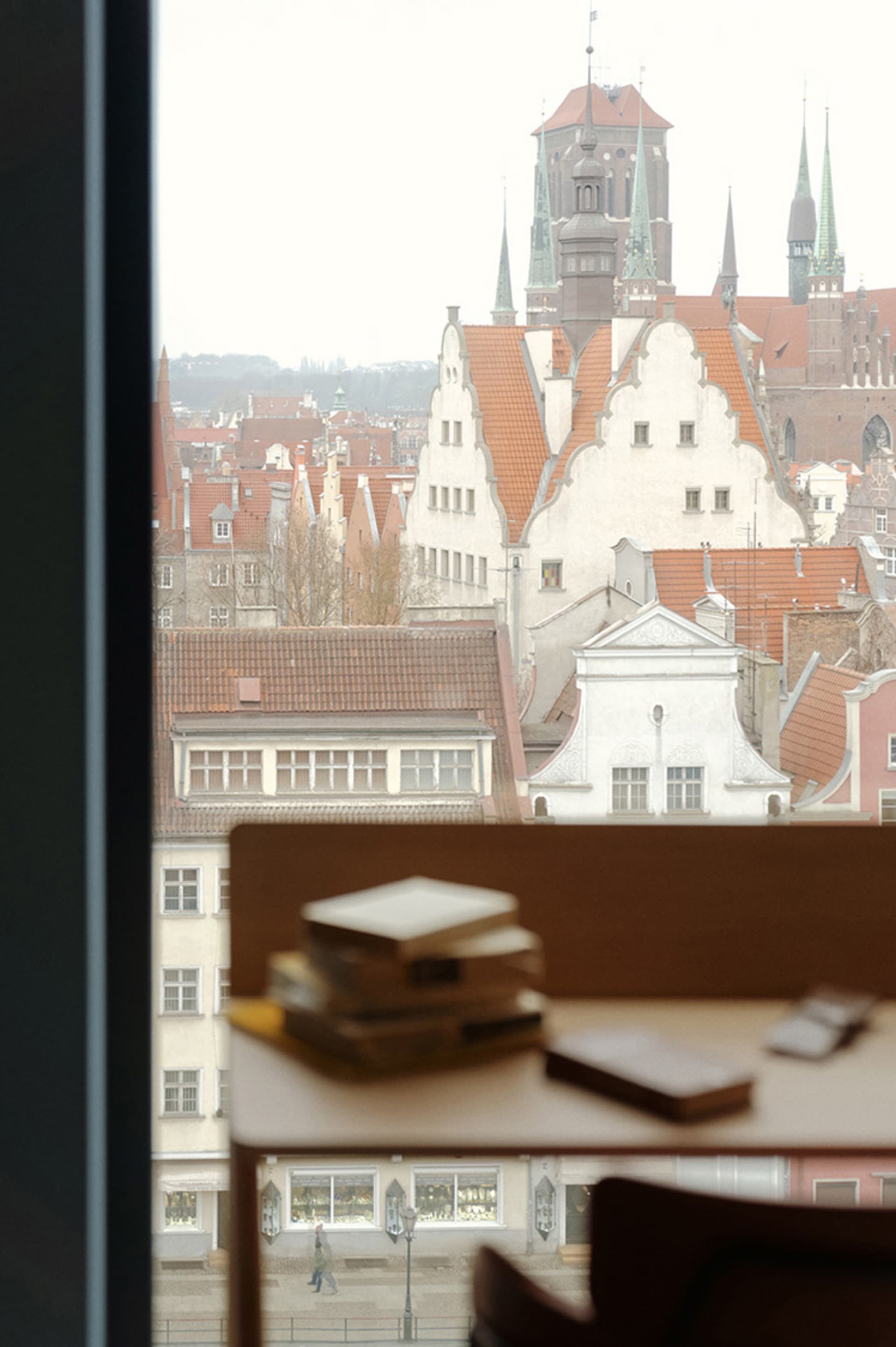 A view of a residential space through a window showing traditional European architecture.