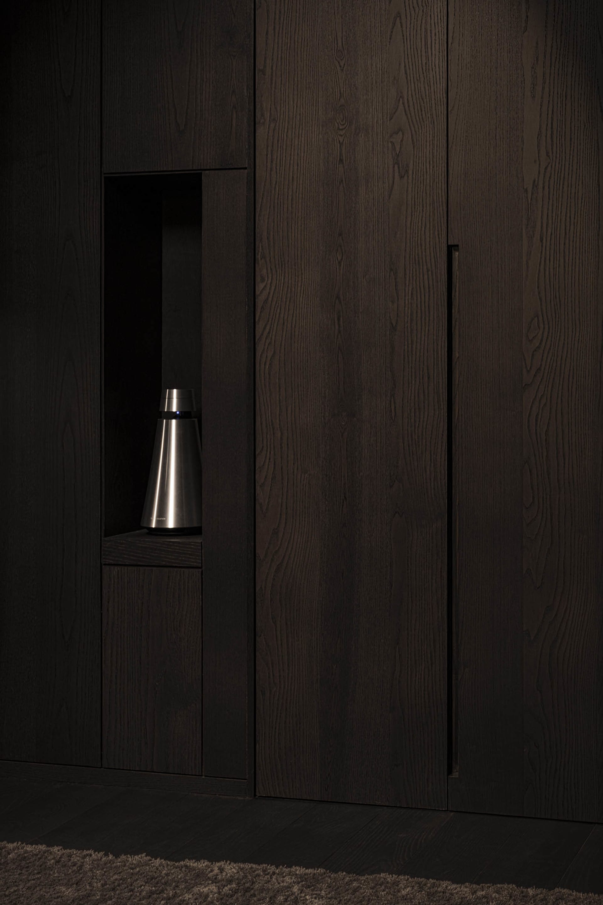 Modern closet with dark wooden panels and built-in storage
