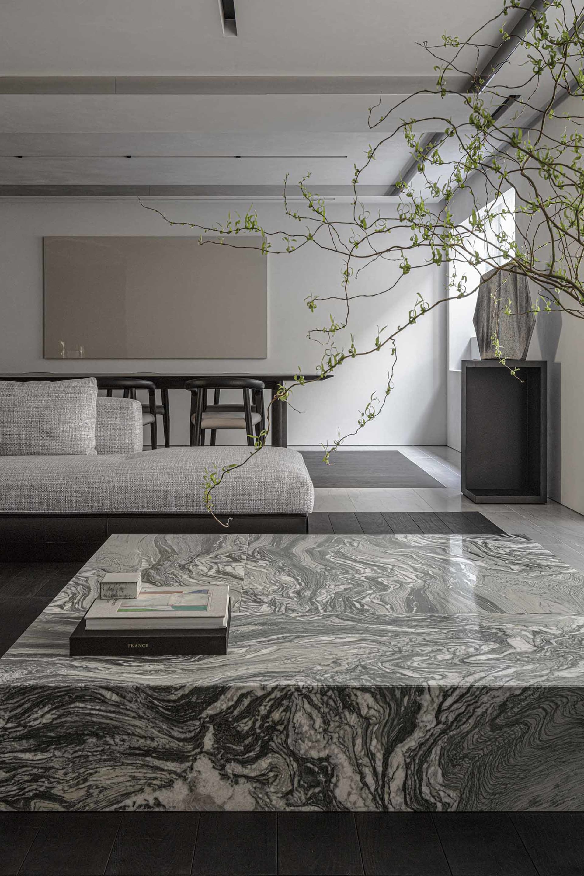 Modern, minimalist living room featuring marble furniture and minimalist decor.