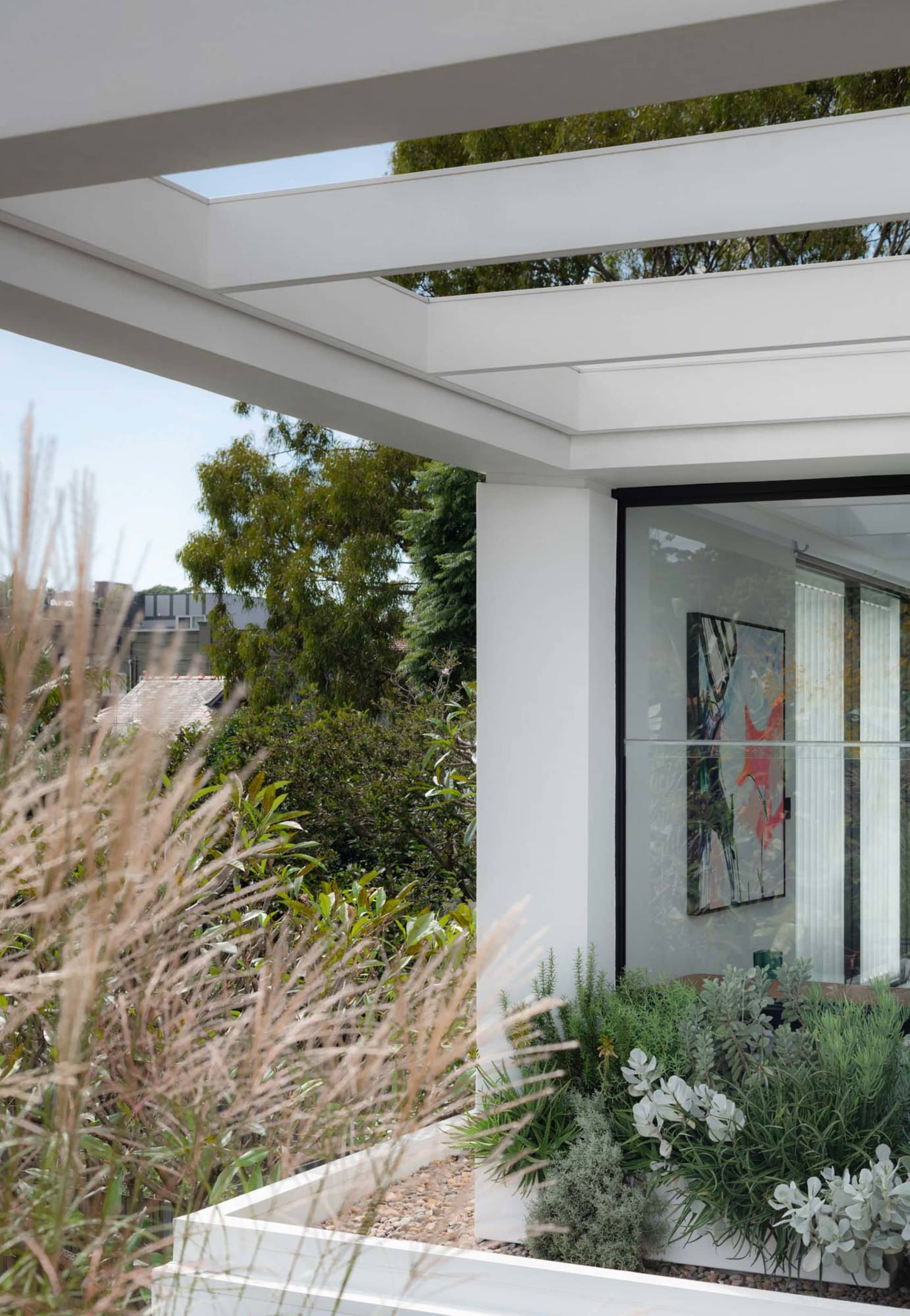 Modern house extension with sleek glass walls and steel beams