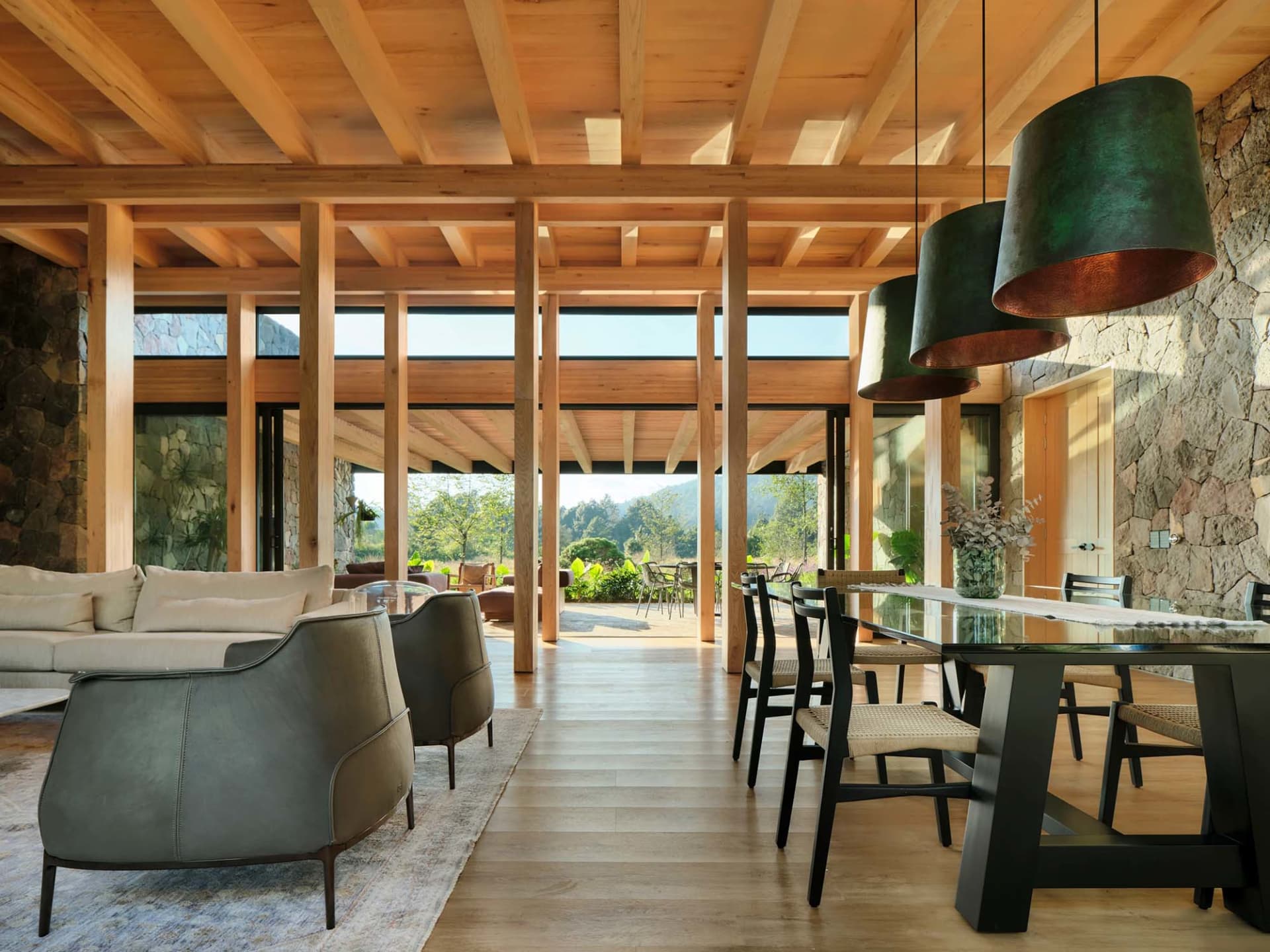Modern interior with wooden beams, sofas, tables, and chairs.