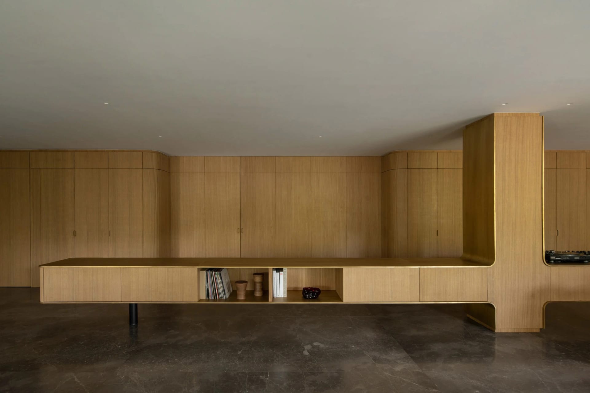 Modern living room featuring wooden furniture and paneling.