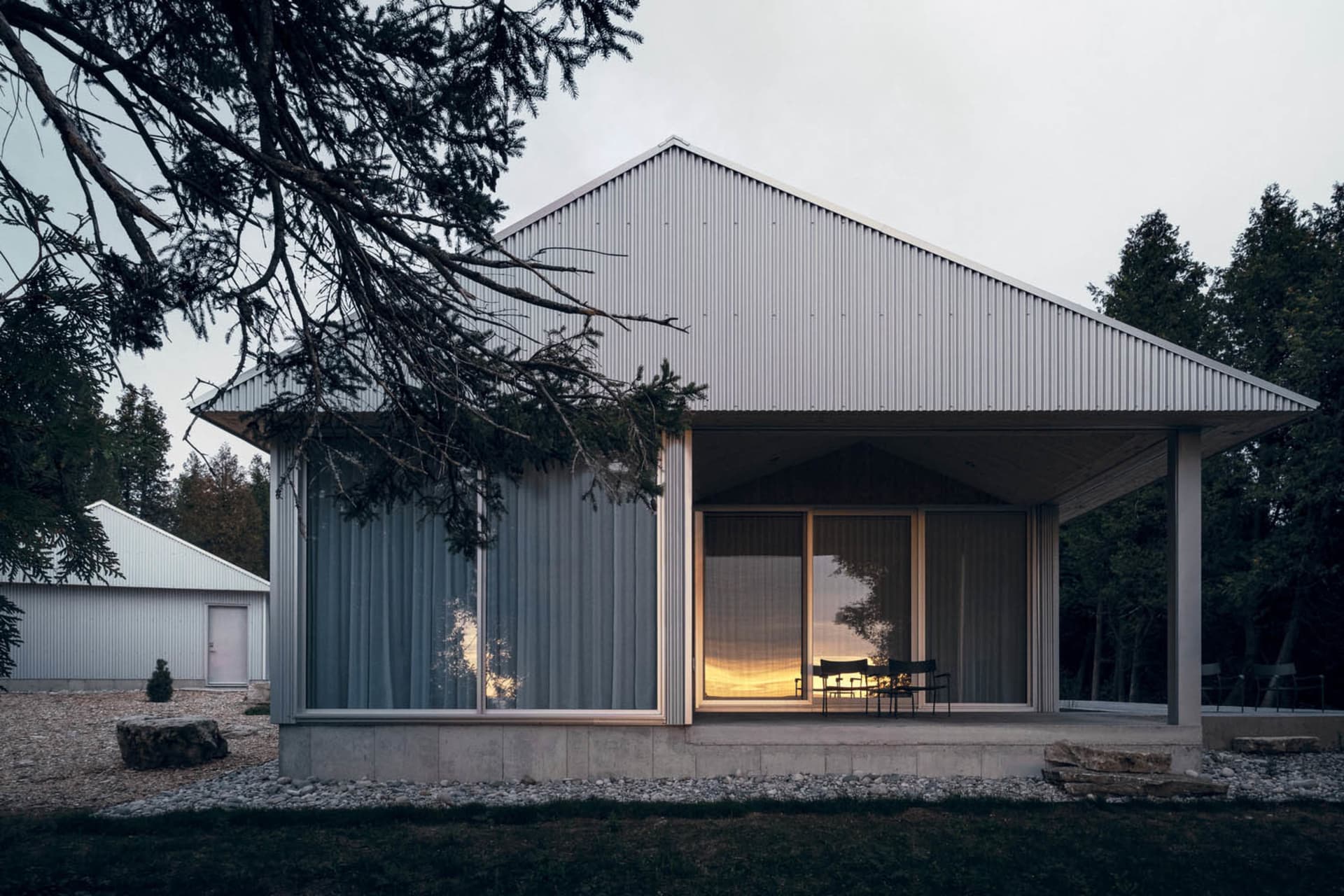 Modern minimalist residential house with metal siding and large glass windows