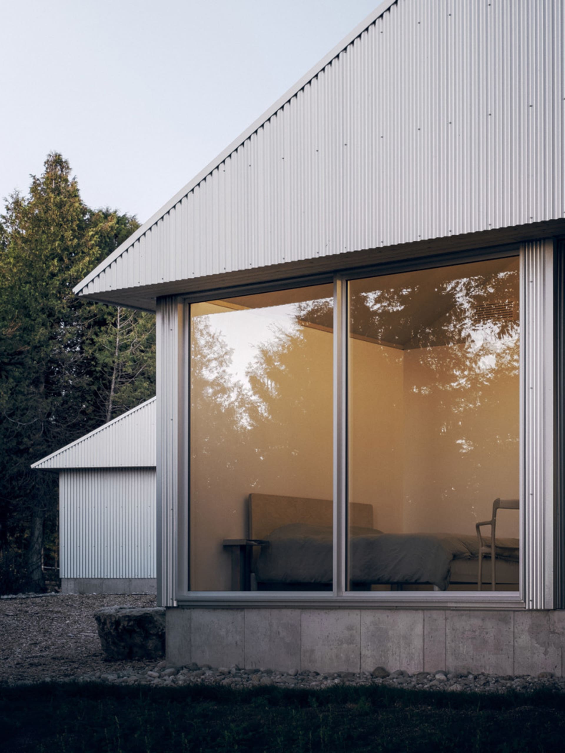 Modern residential architecture featuring glass and metal materials.