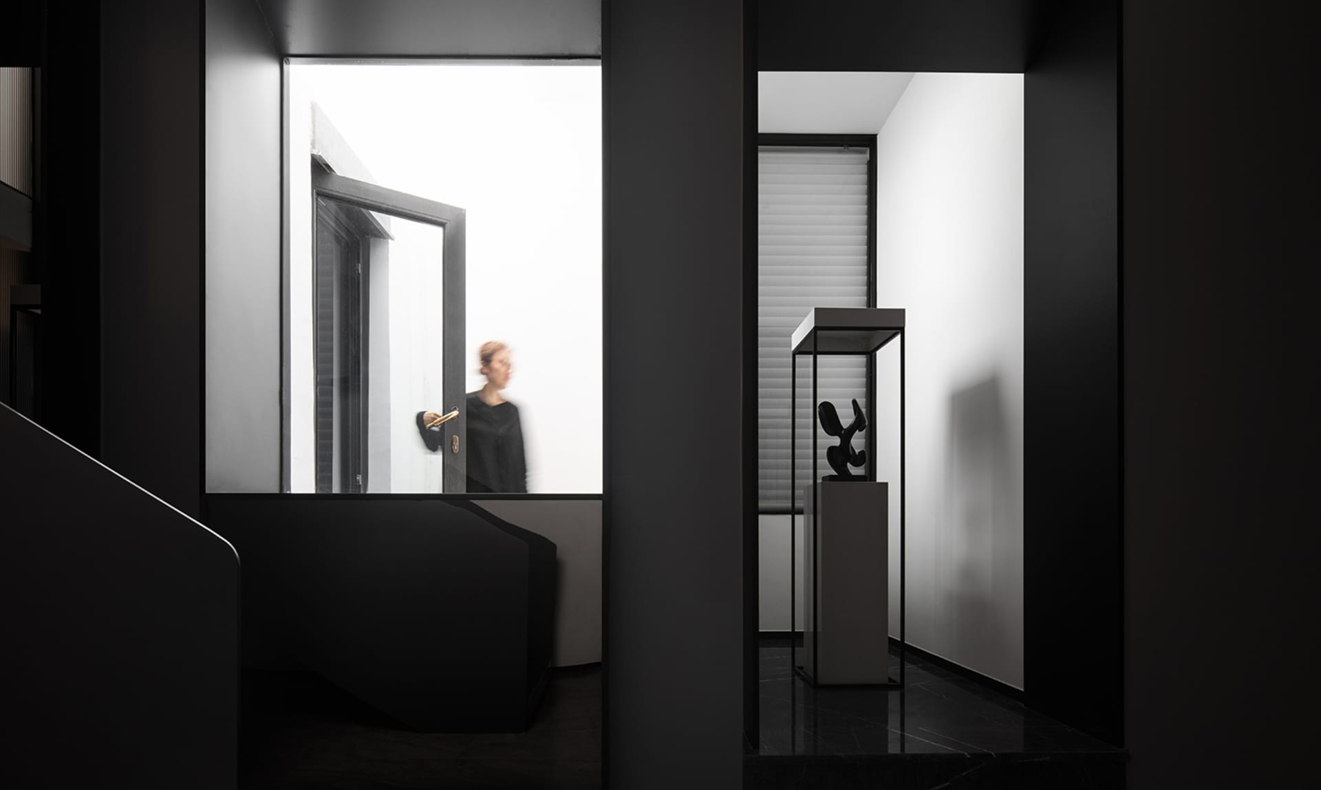 Modern interior design featuring black and white color scheme and metallic elements.
