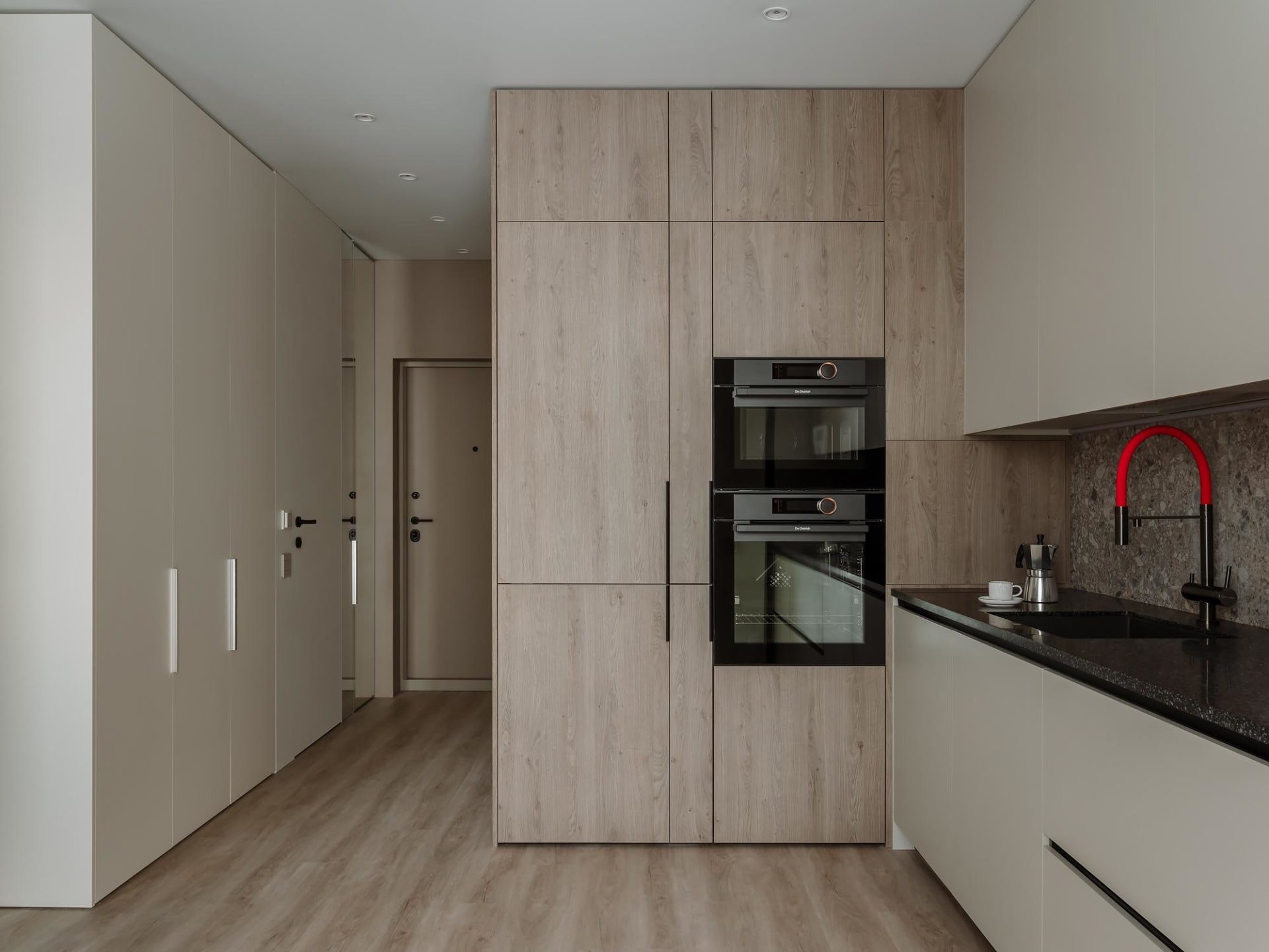 Modern minimalist kitchen featuring wood cabinets and a sleek, integrated design.