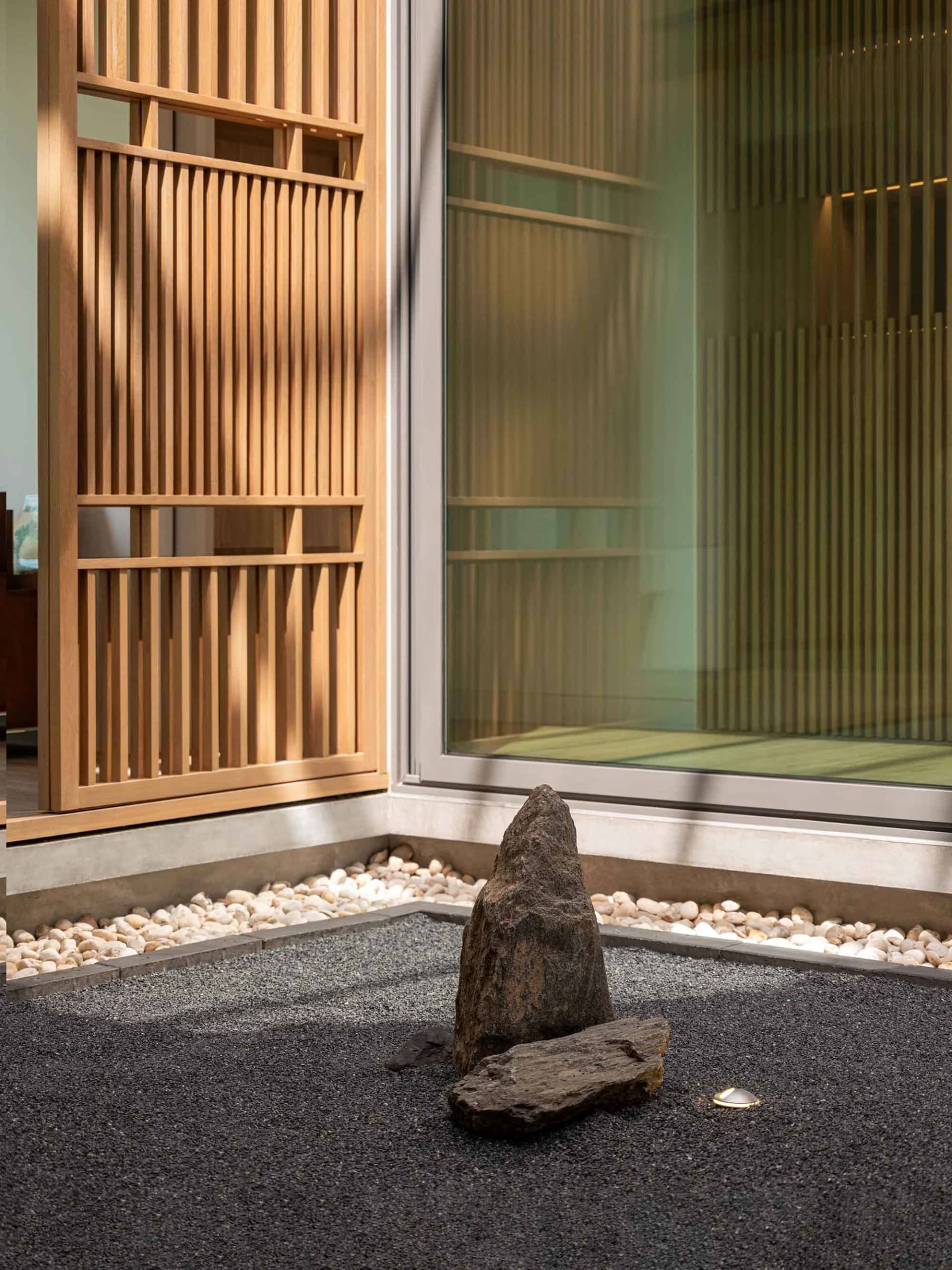 A minimalist Japanese-inspired garden with natural stones and gravel