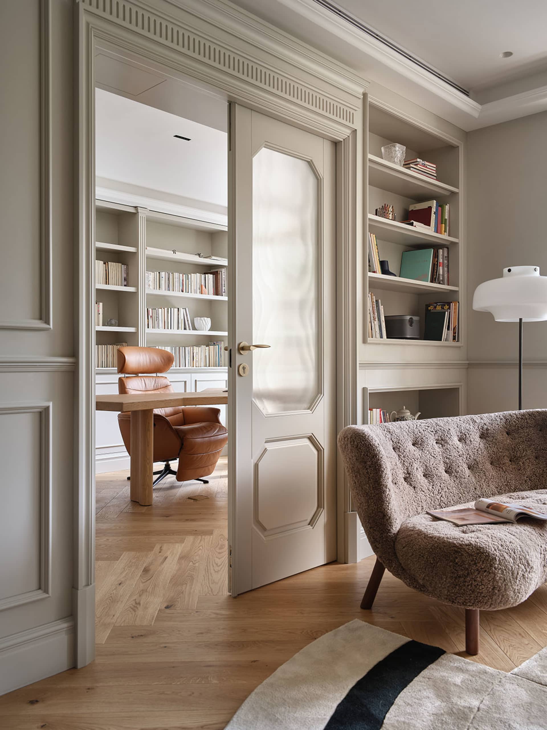 A modern library office featuring wooden furniture and bookshelves.