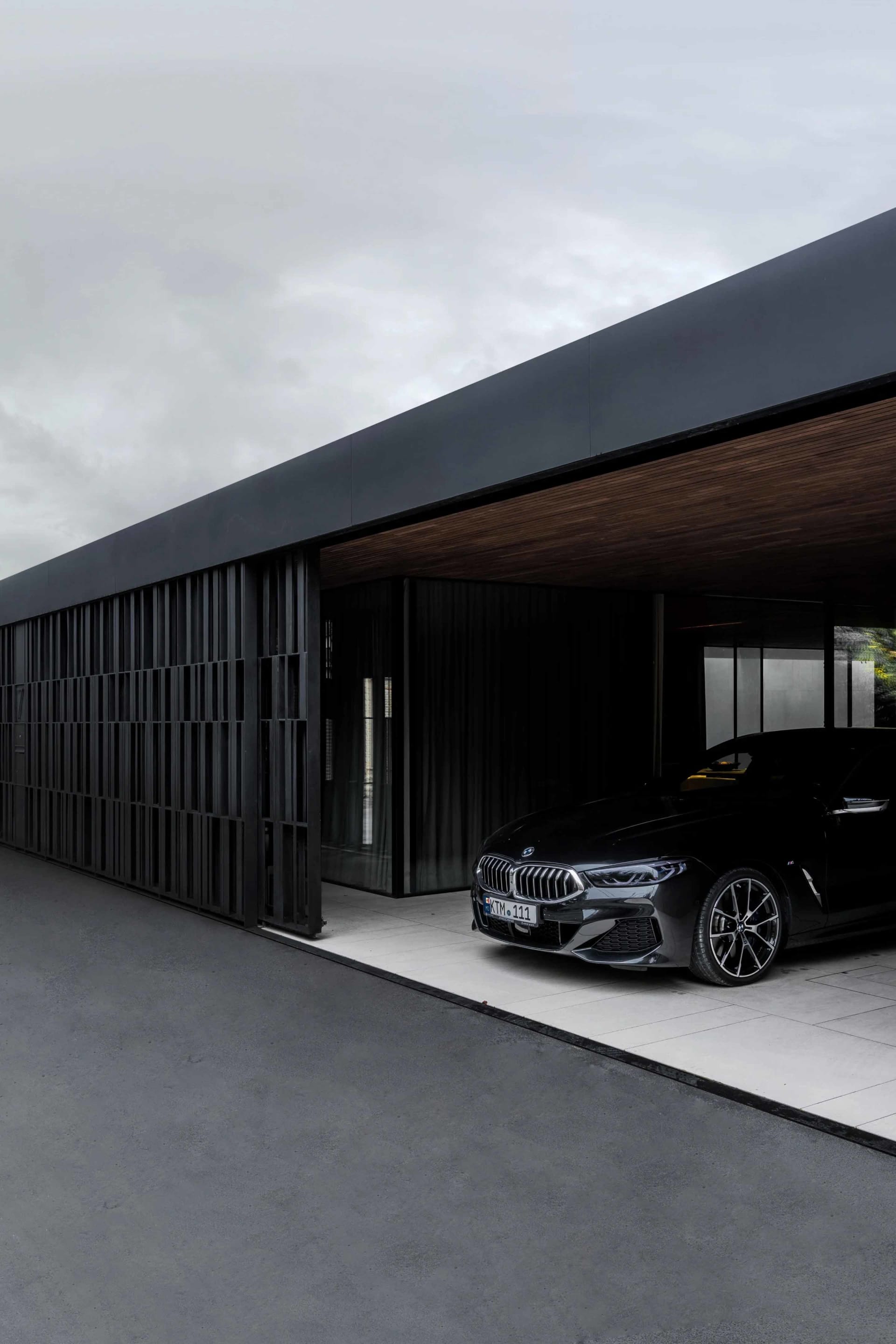 A modern building exterior featuring a combination of concrete and glass materials.
