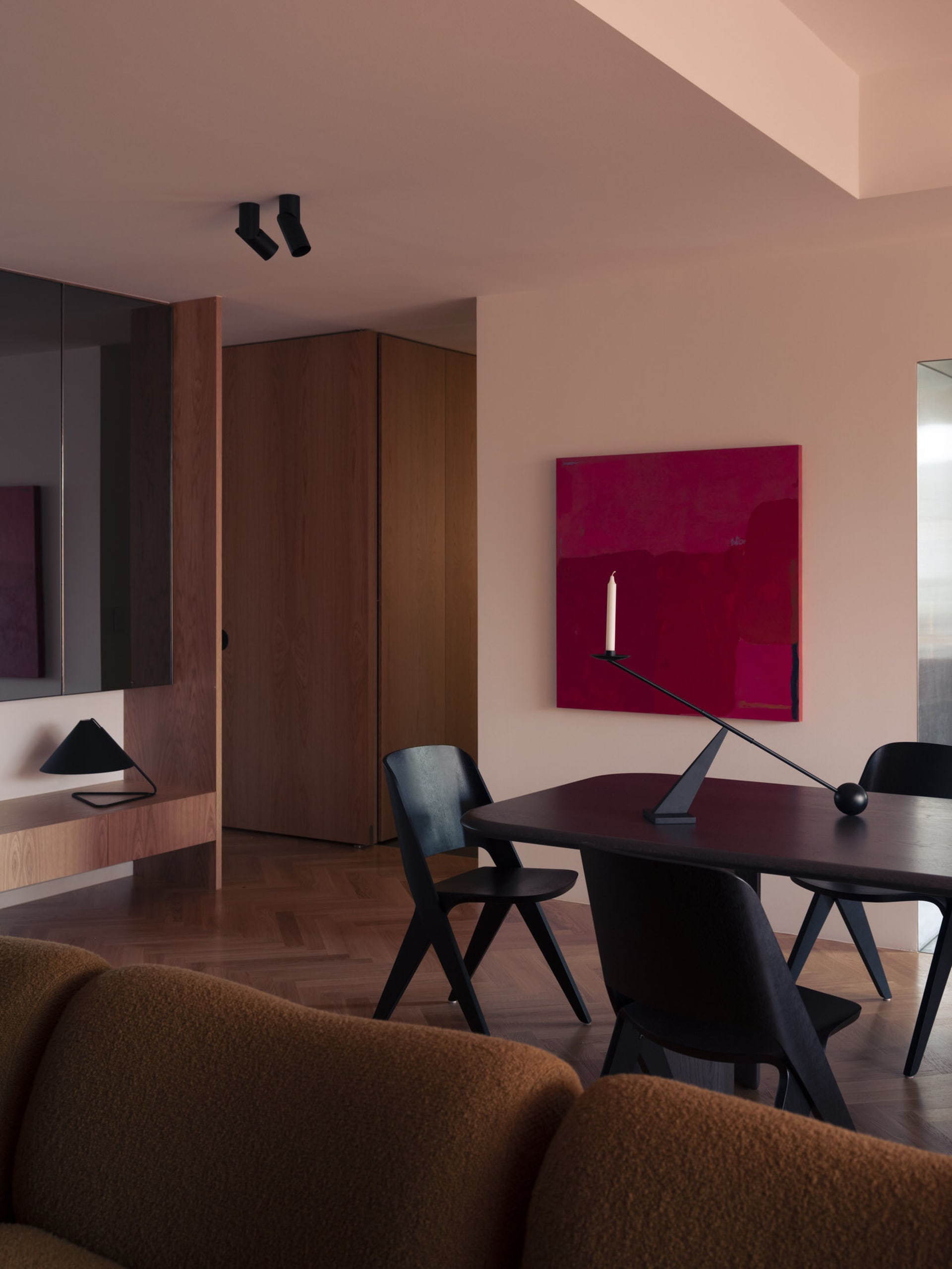 A modern residential interior featuring a combination of wooden, metallic, and fabric elements.