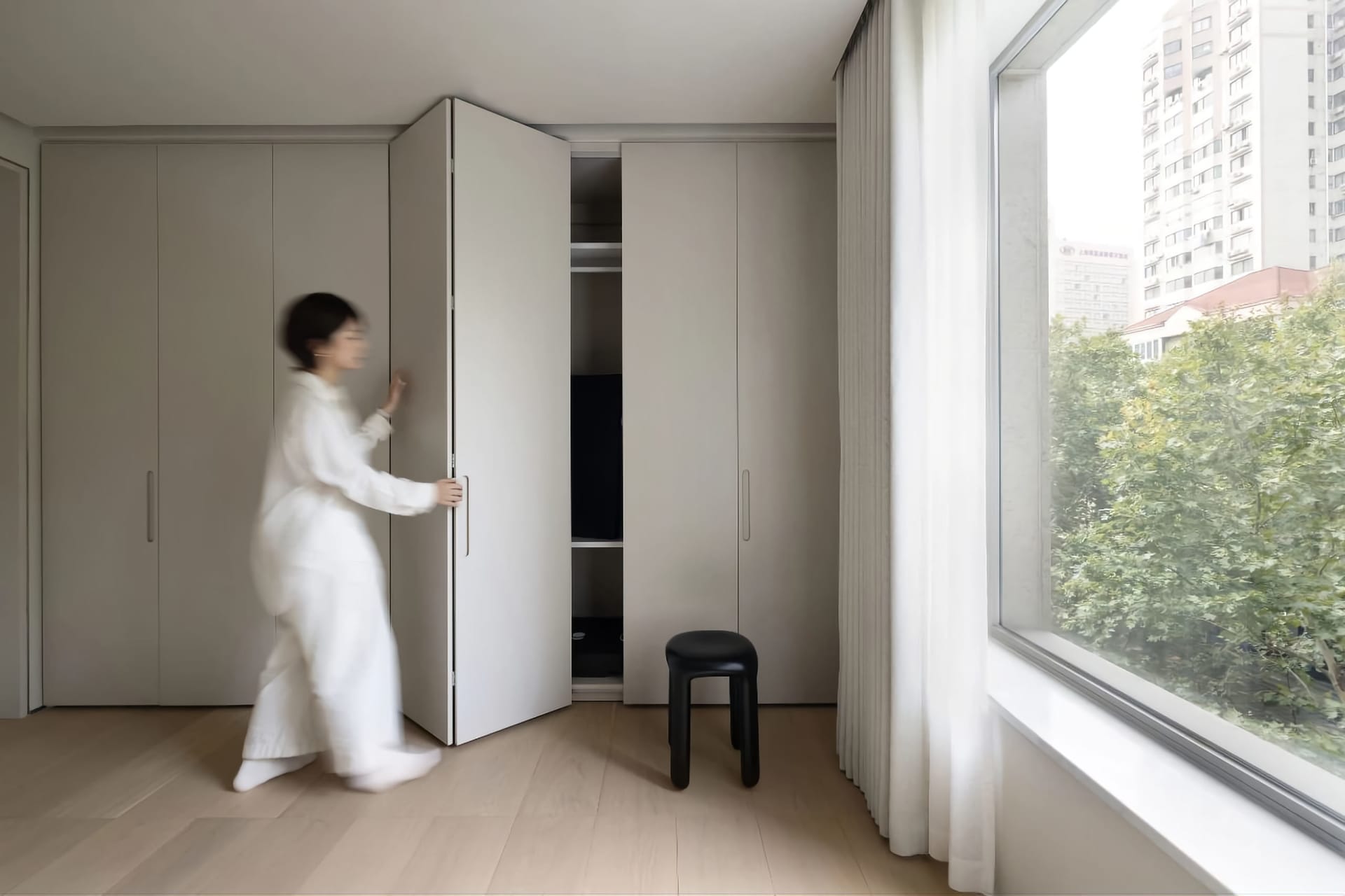 A minimalist interior features white cabinets, offering a modern and sleek look.