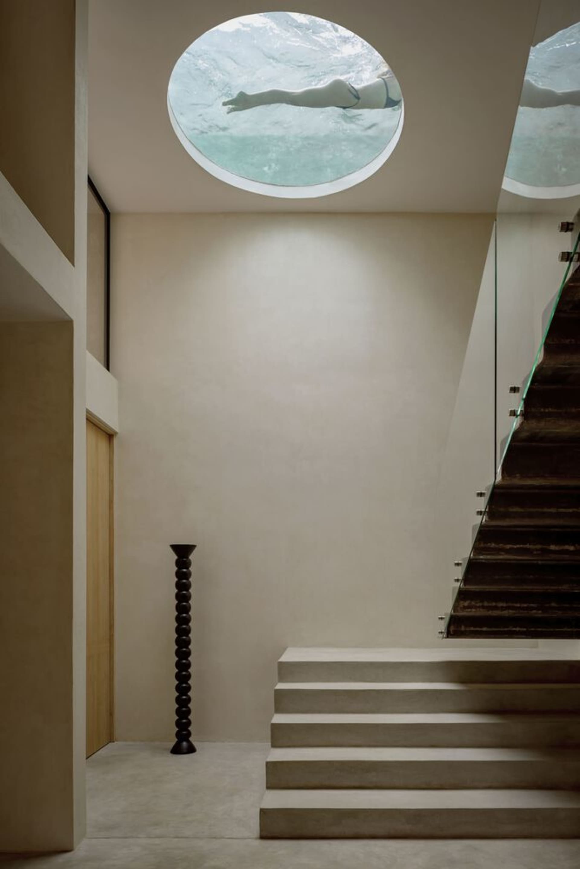 Modern interior with concrete stairs and glass wall
