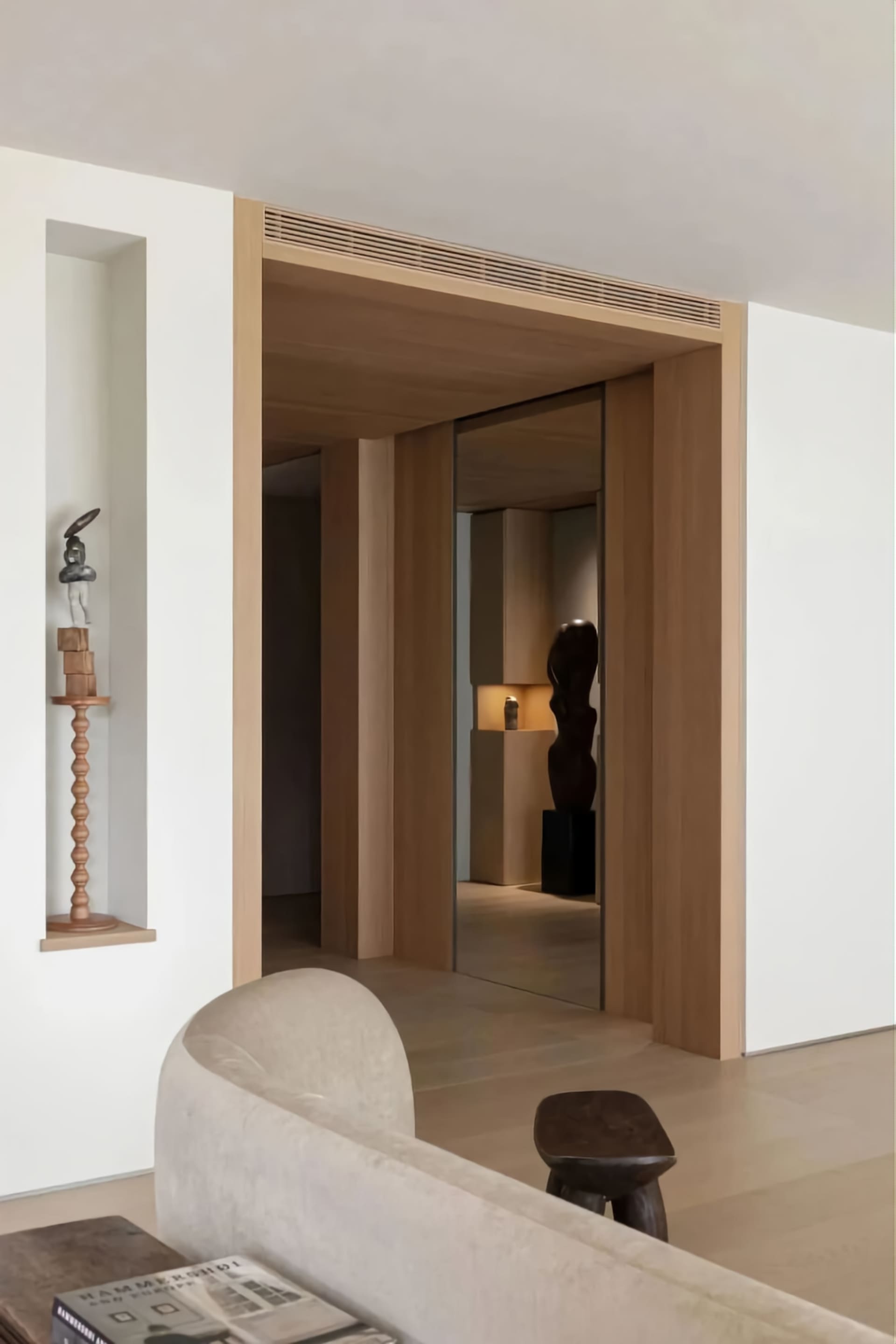 A modern living room featuring wooden furniture, minimalist design, and clean lines.